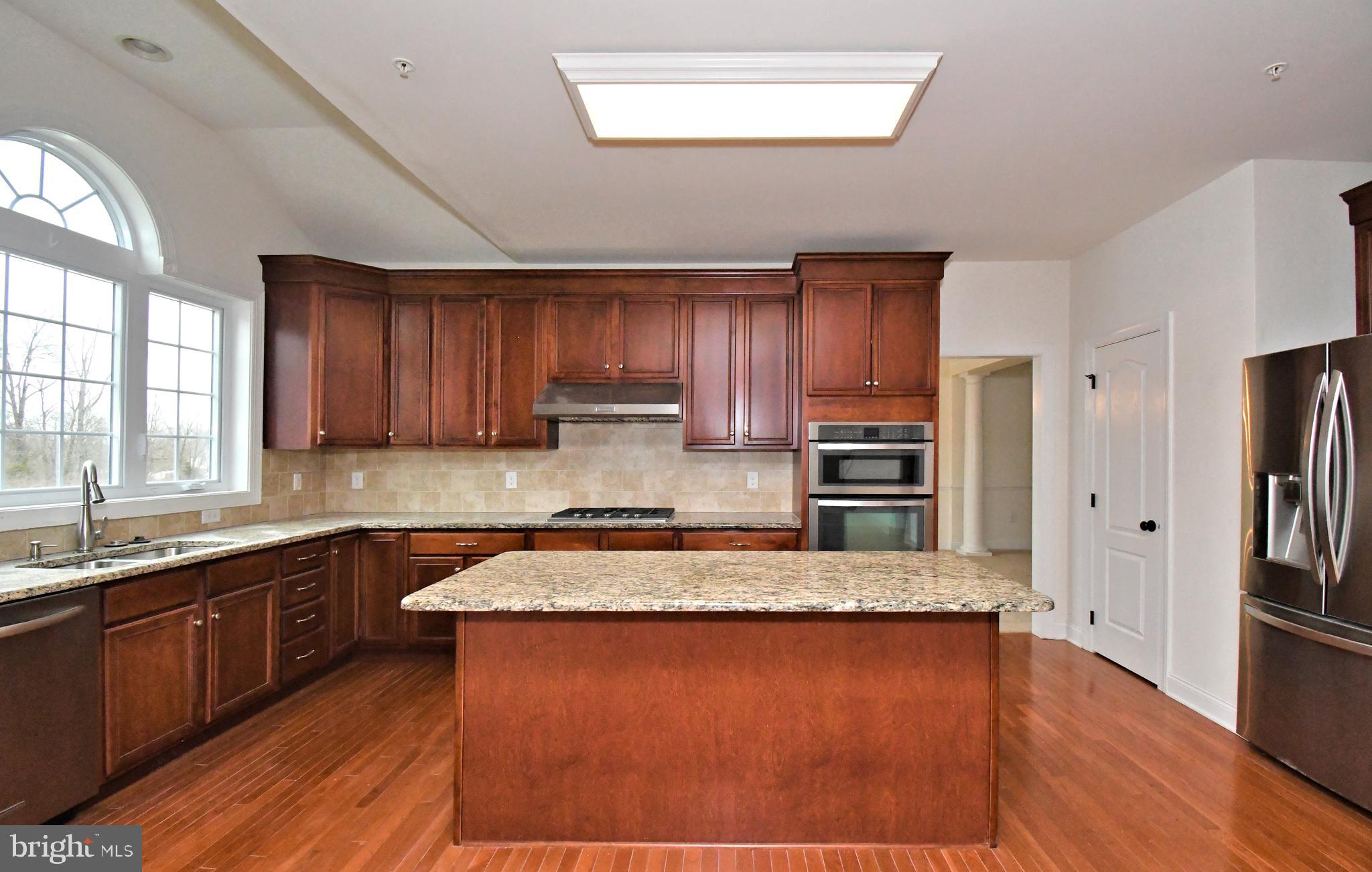 2804 Hoffs Way Warrington, PA 18976 - Photo 17 of 63 a large kitchen with wooden floors and wooden cabinets