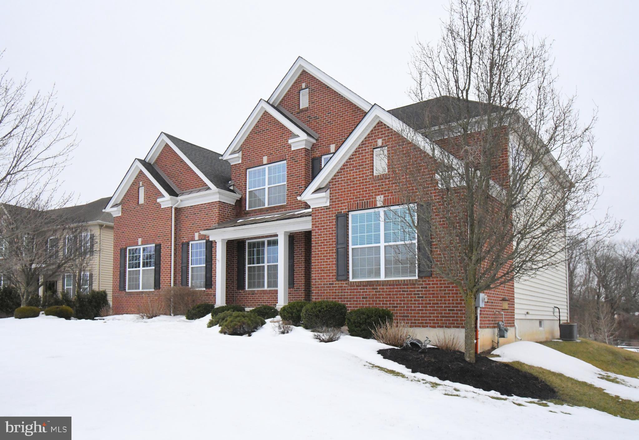 2804 Hoffs Way Warrington, PA 18976 - Photo 2 of 63 a front view of a house with a yard covered in snow