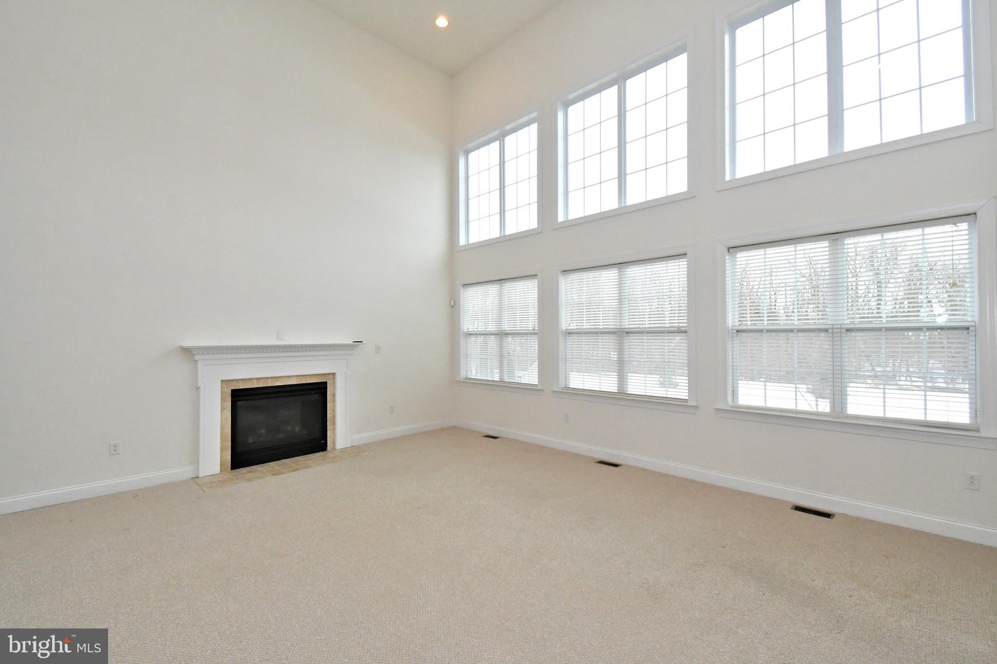 2804 Hoffs Way Warrington, PA 18976 - Photo 24 of 63 an empty room with a fireplace and windows