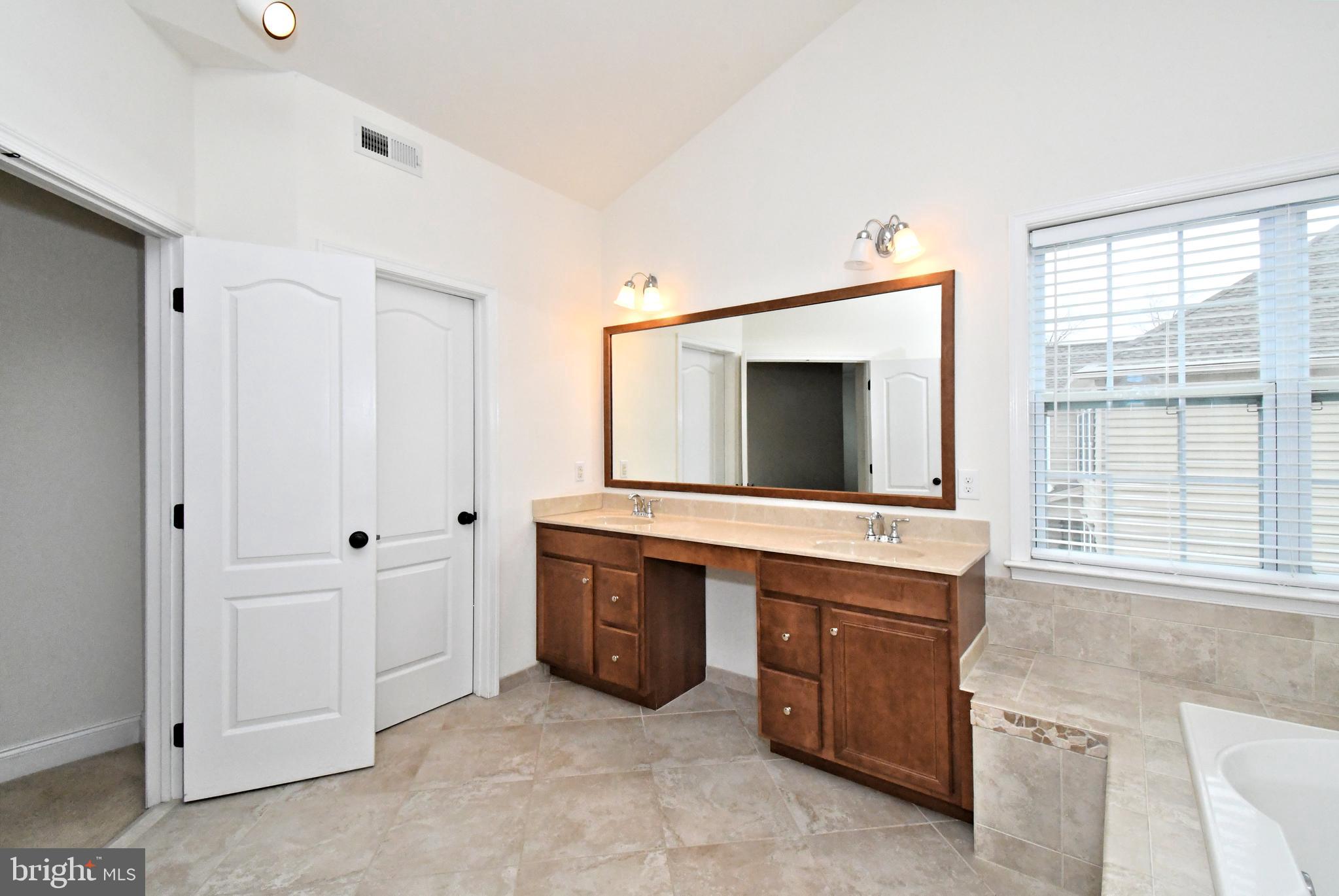 2804 Hoffs Way Warrington, PA 18976 - Photo 36 of 63 a spacious bathroom with a granite countertop sink and a mirror