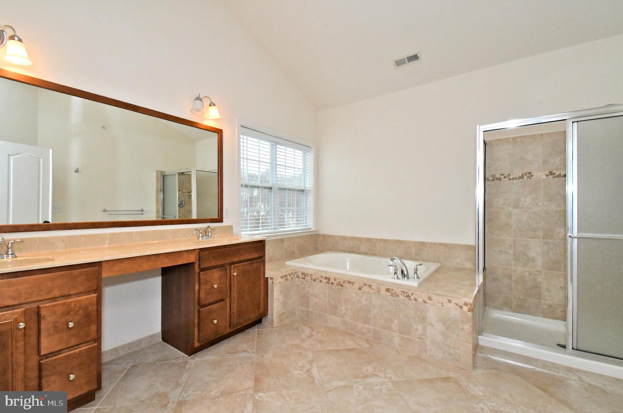 2804 Hoffs Way Warrington, PA 18976 - Photo 38 of 63 a spacious bathroom with a granite countertop tub sink and mirror