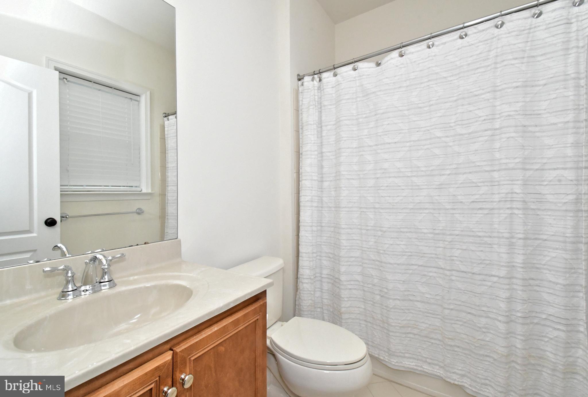 2804 Hoffs Way Warrington, PA 18976 - Photo 47 of 63 a bathroom with a sink a toilet and shower curtain