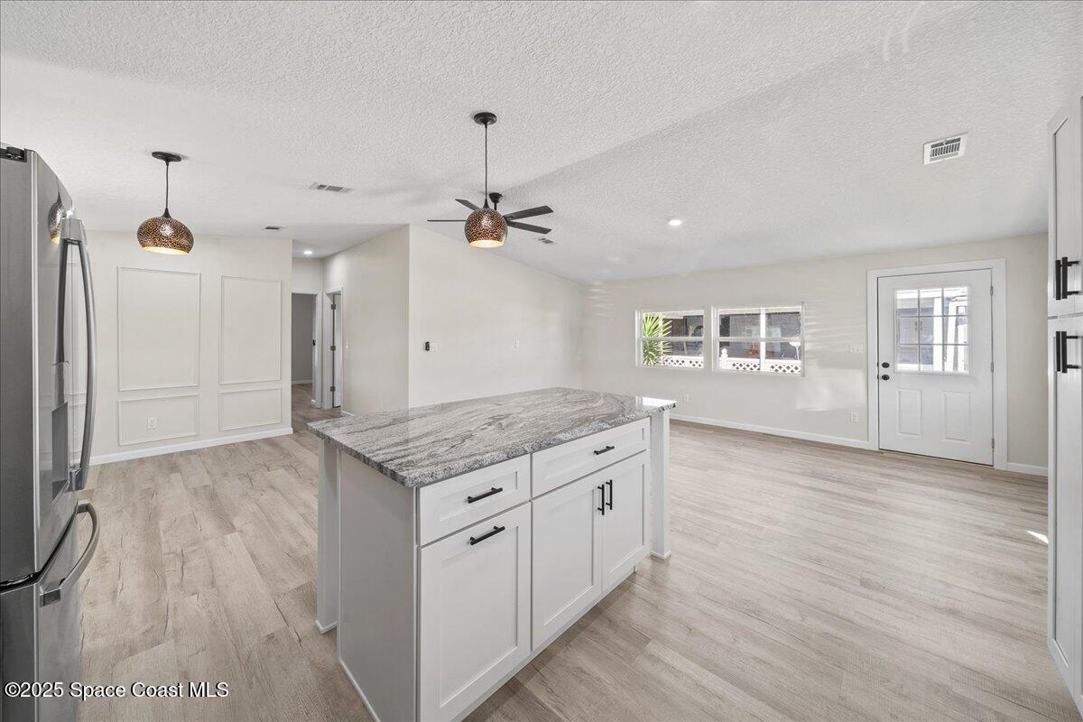 1924 Big Cypress Street Northeast Palm Bay, FL 32905 - Photo 15 of 29 a kitchen with a stove and a wooden floor