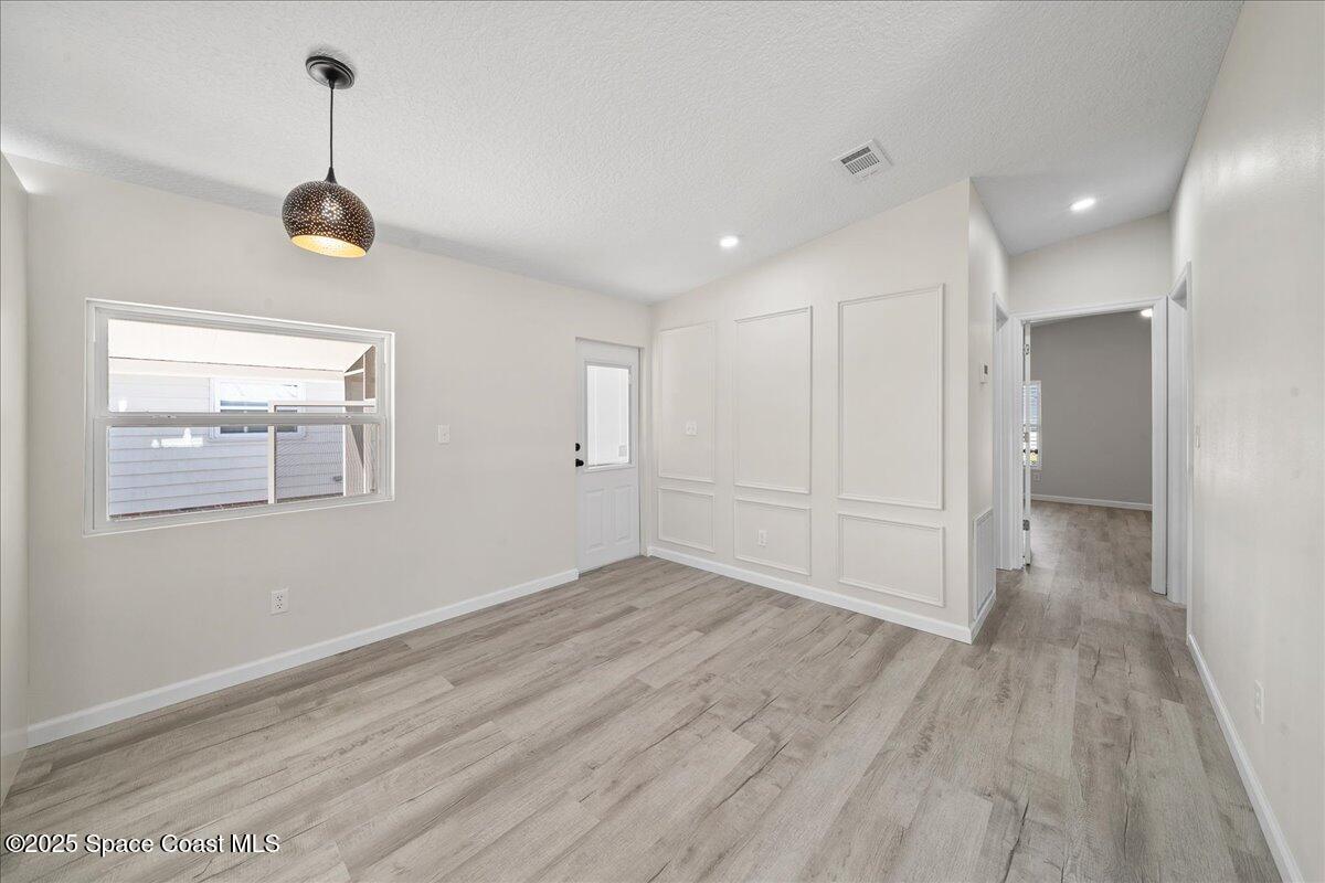 1924 Big Cypress Street Northeast Palm Bay, FL 32905 - Photo 17 of 29 a view of a room with wooden floor ceiling fan and window