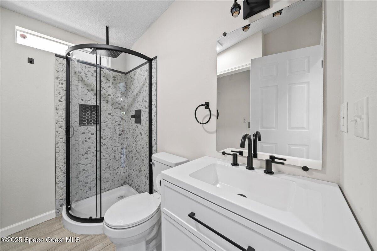 1924 Big Cypress Street Northeast Palm Bay, FL 32905 - Photo 24 of 29 a bathroom with a sink a toilet and shower