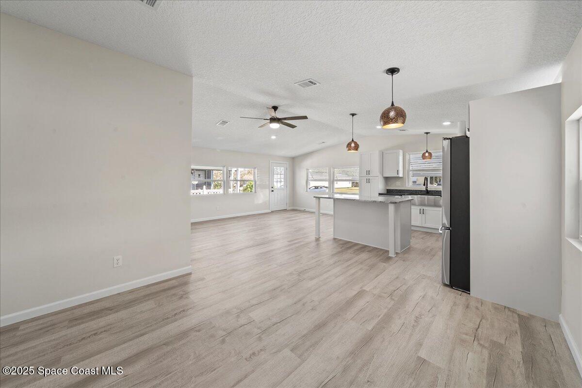 1924 Big Cypress Street Northeast Palm Bay, FL 32905 - Photo 7 of 29 a view of a kitchen with wooden floor and electronic appliances