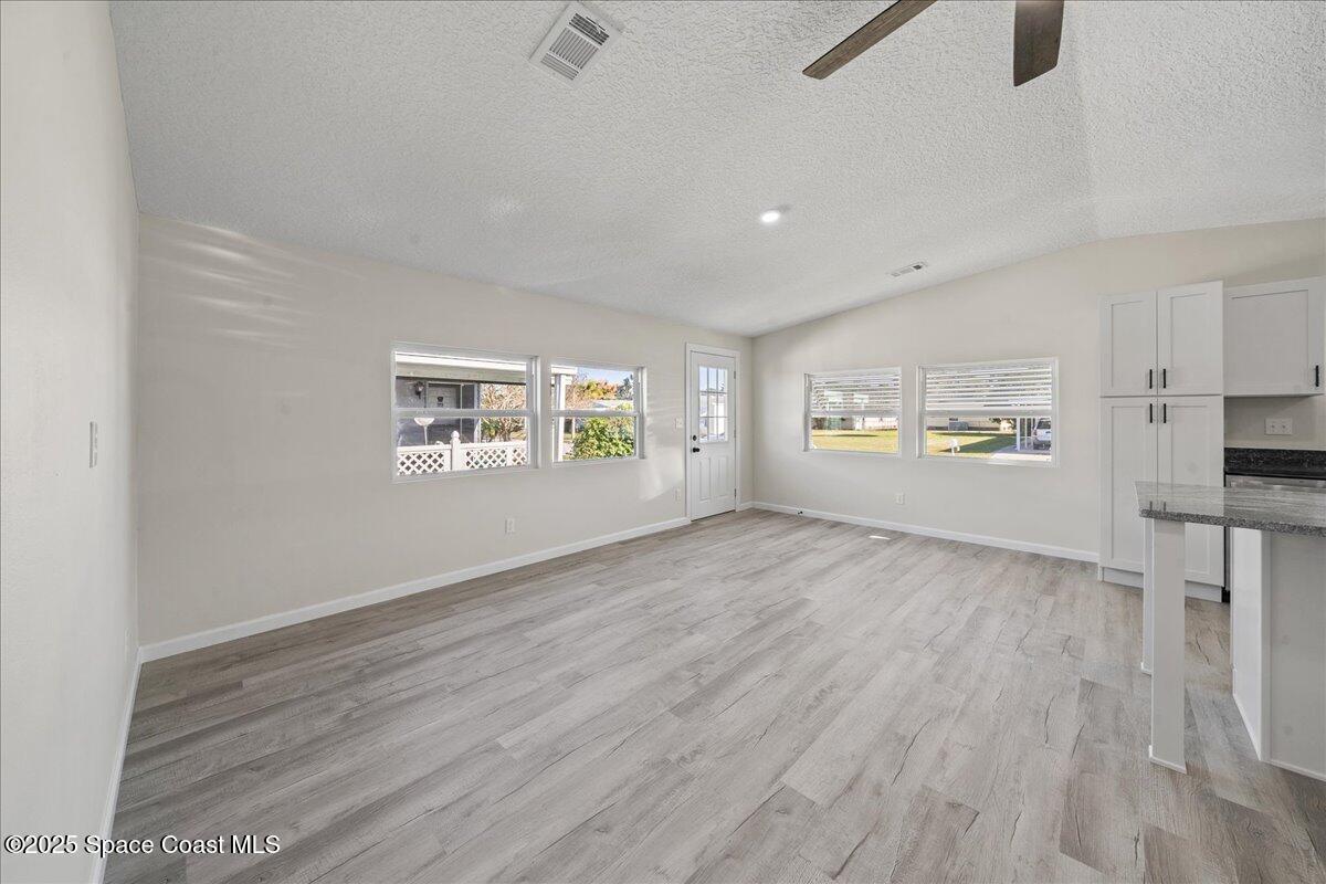 1924 Big Cypress Street Northeast Palm Bay, FL 32905 - Photo 8 of 29 wooden floor in an empty room with a window