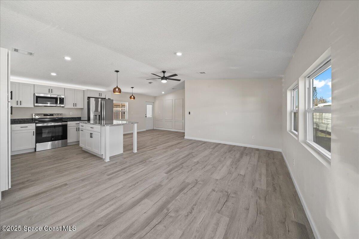 1924 Big Cypress Street Northeast Palm Bay, FL 32905 - Photo 9 of 29 a view of kitchen with wooden floor and electronic appliances