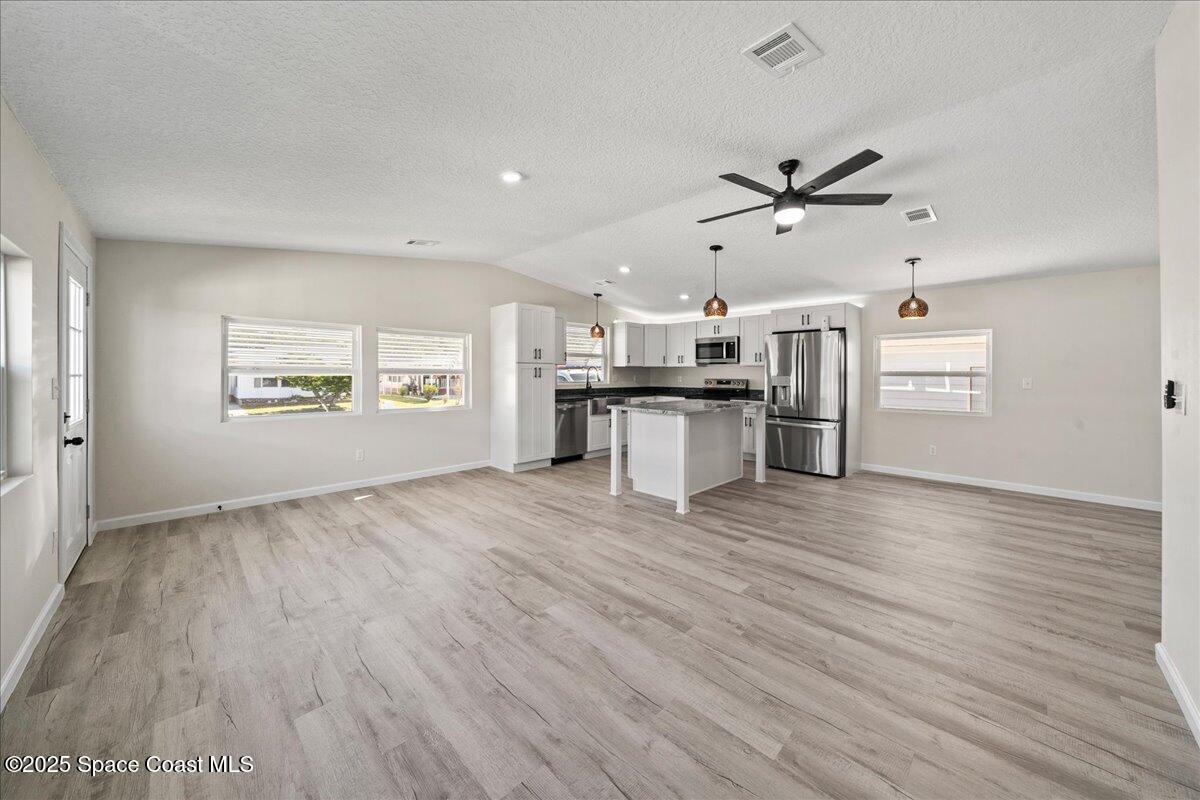 1924 Big Cypress Street Northeast Palm Bay, FL 32905 - Photo 10 of 29 a view of a kitchen with wooden floor a sink a refrigerator and window
