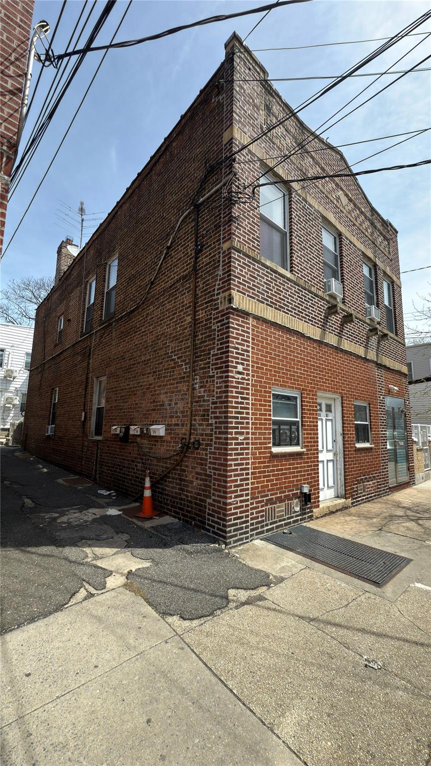 55-07 103rd Street Queens, NY 11368 - Photo 2 of 10 View of side of home featuring brick siding and cooling unit
