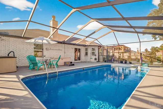 a view of a patio with a table and chairs