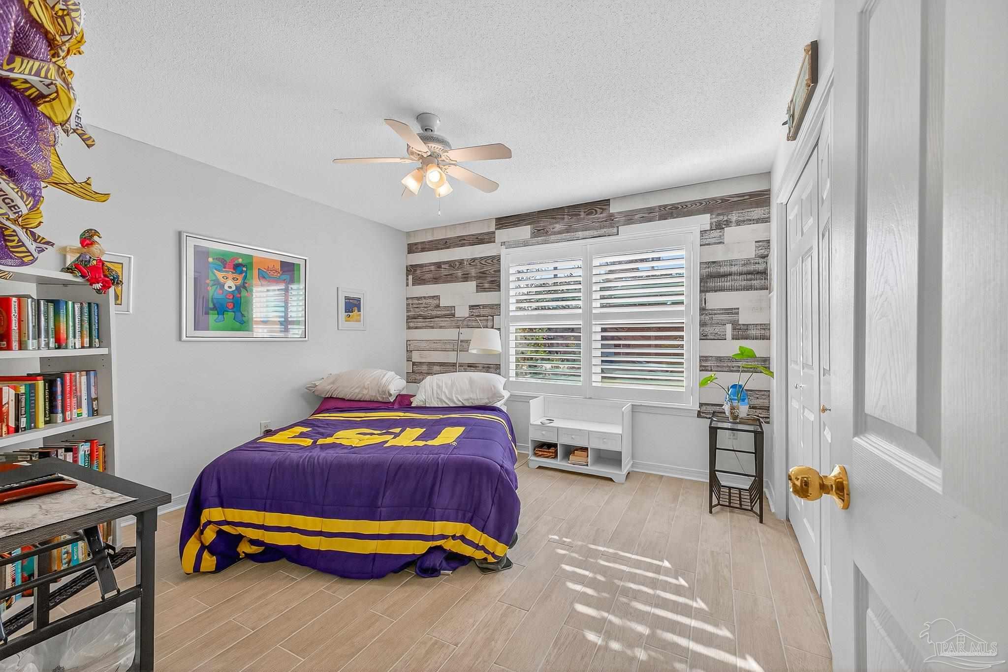 4650 Ridge Pointe Drive Pace, FL 32571 - Photo 11 of 38 a bedroom with a bed and a book shelf