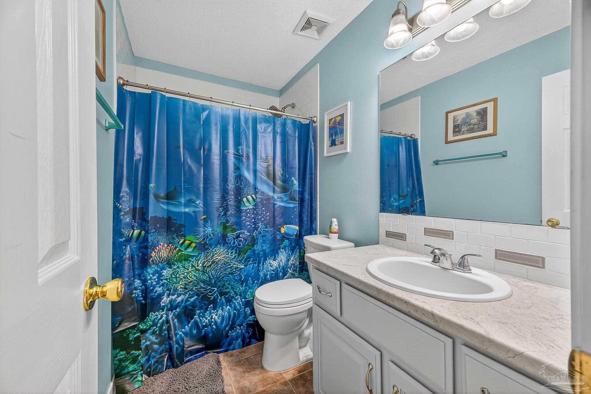 4650 Ridge Pointe Drive Pace, FL 32571 - Photo 12 of 38 a bathroom with a sink toilet and shower