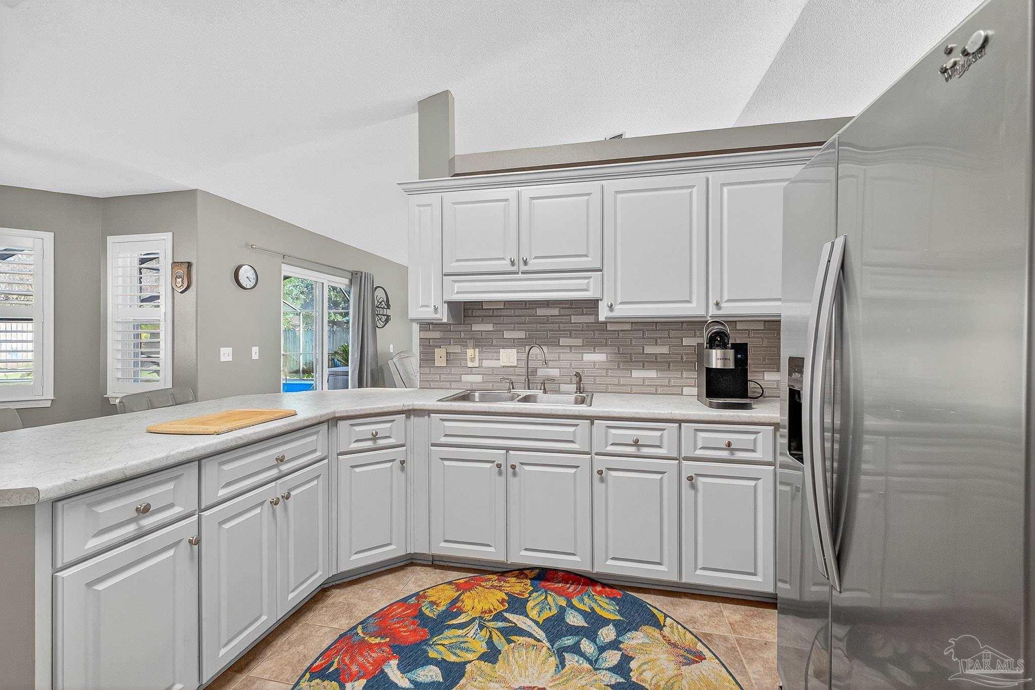 4650 Ridge Pointe Drive Pace, FL 32571 - Photo 17 of 38 a kitchen with stainless steel appliances granite countertop a sink and cabinets