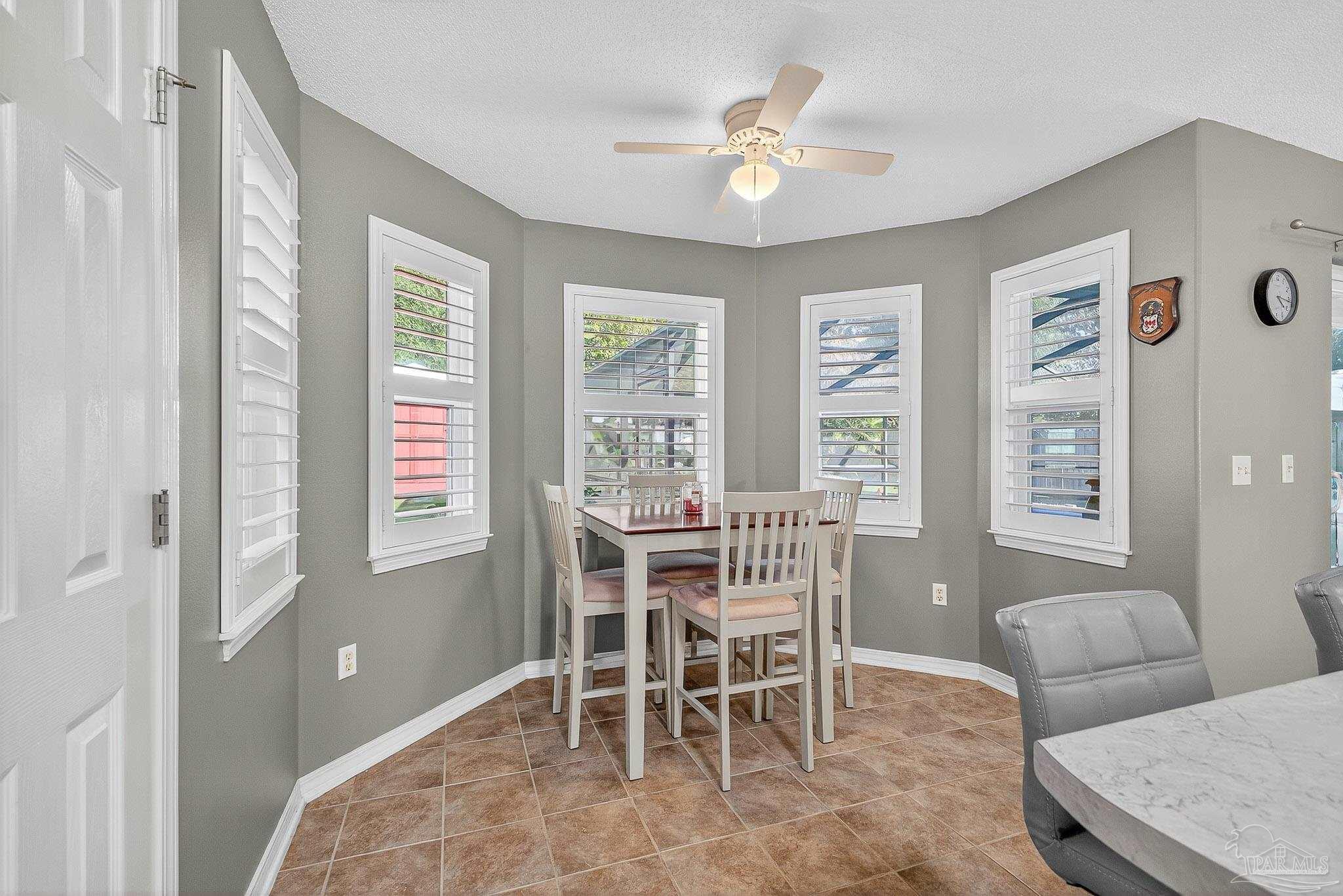 4650 Ridge Pointe Drive Pace, FL 32571 - Photo 20 of 38 a dining room with furniture and window