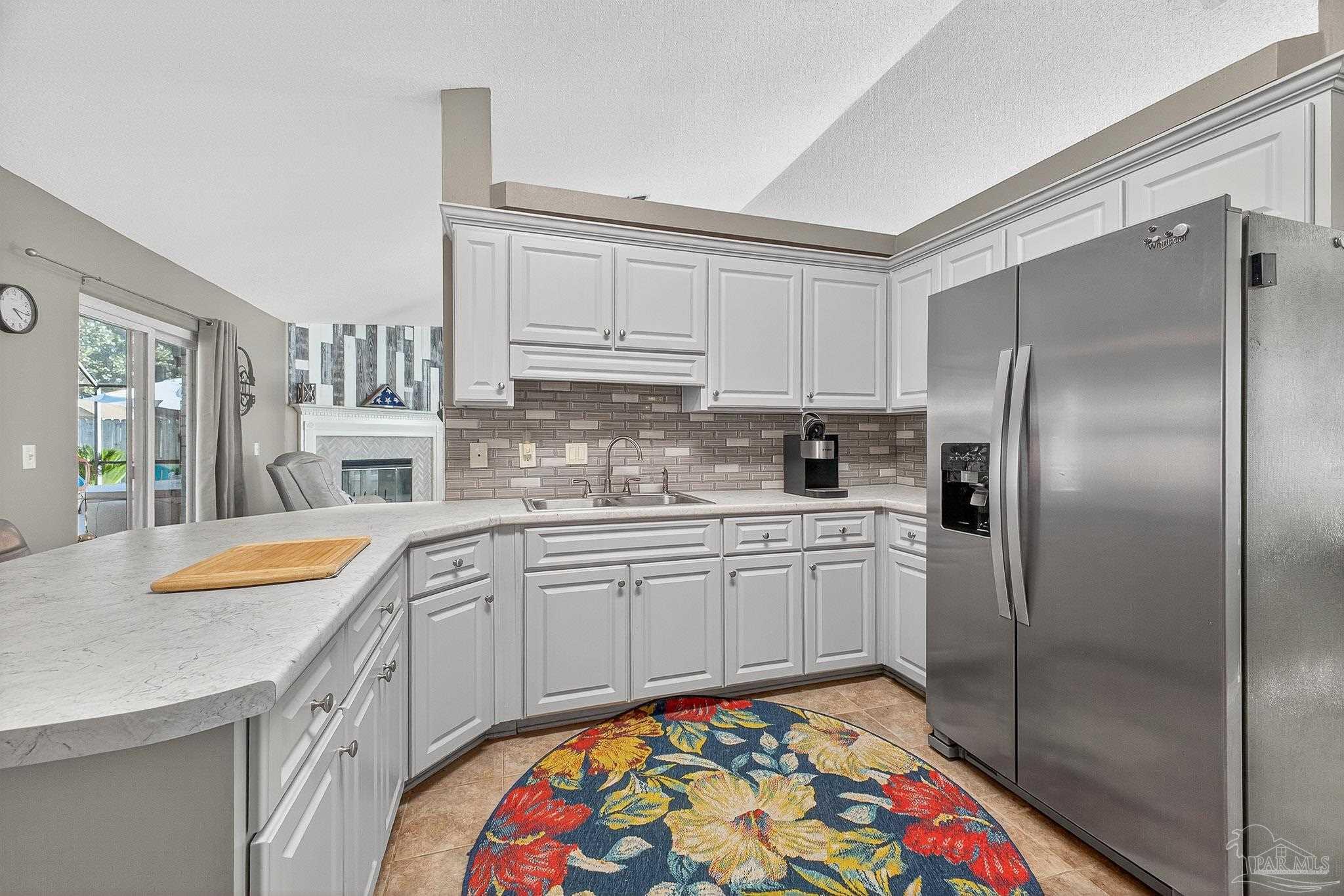 4650 Ridge Pointe Drive Pace, FL 32571 - Photo 22 of 38 a kitchen with stainless steel appliances granite countertop a sink and cabinets