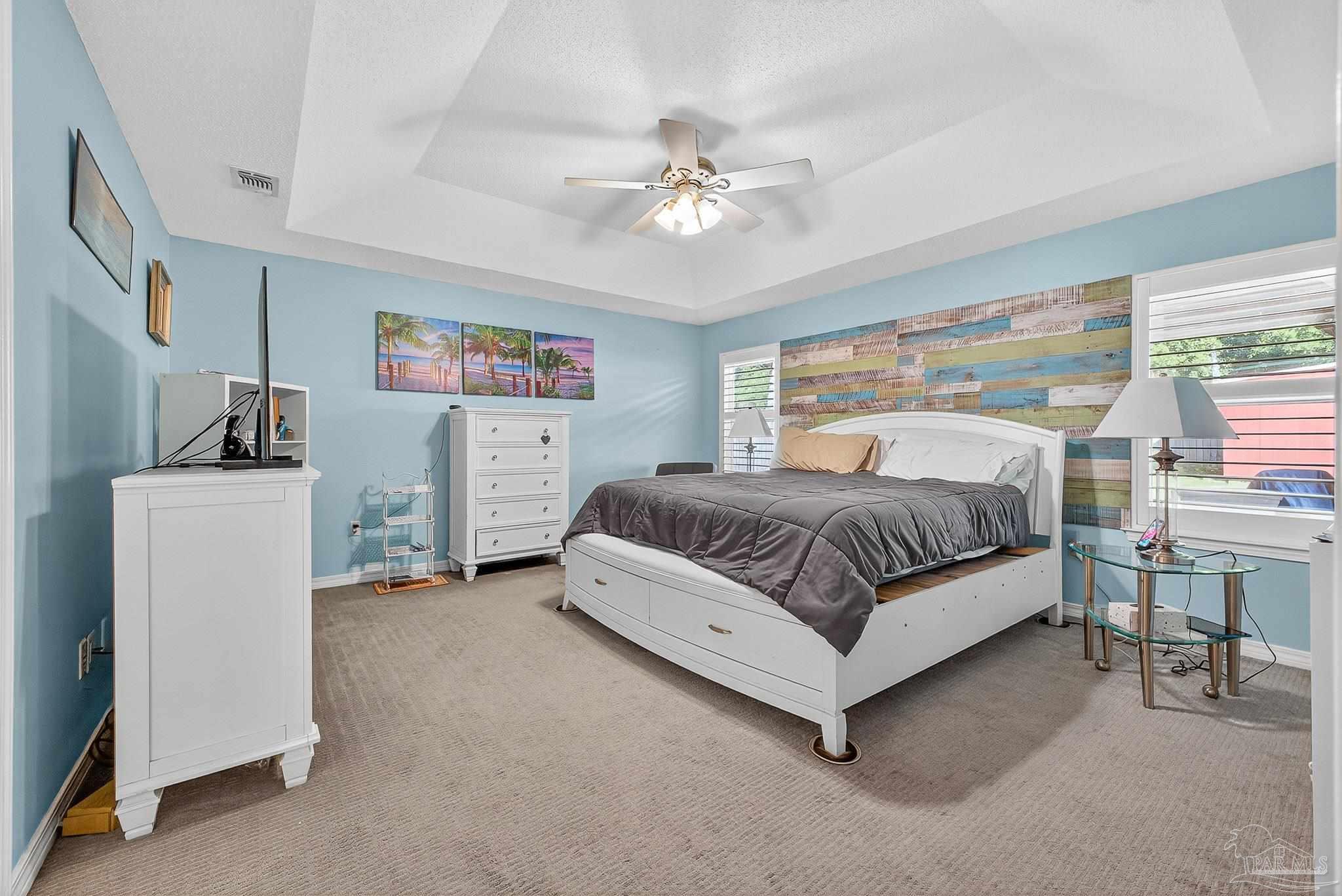 4650 Ridge Pointe Drive Pace, FL 32571 - Photo 23 of 38 a bedroom with a bed and a chandelier