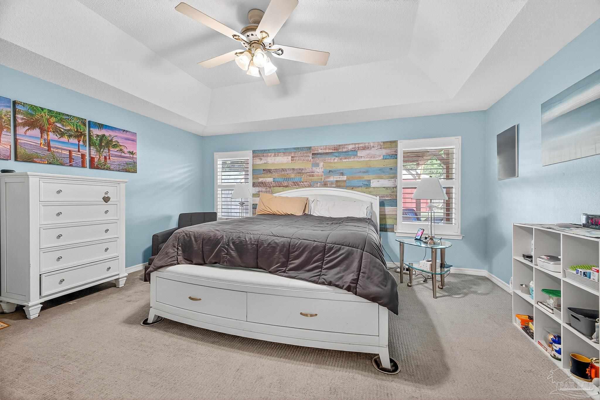 4650 Ridge Pointe Drive Pace, FL 32571 - Photo 24 of 38 a bedroom with a bed and a chandelier