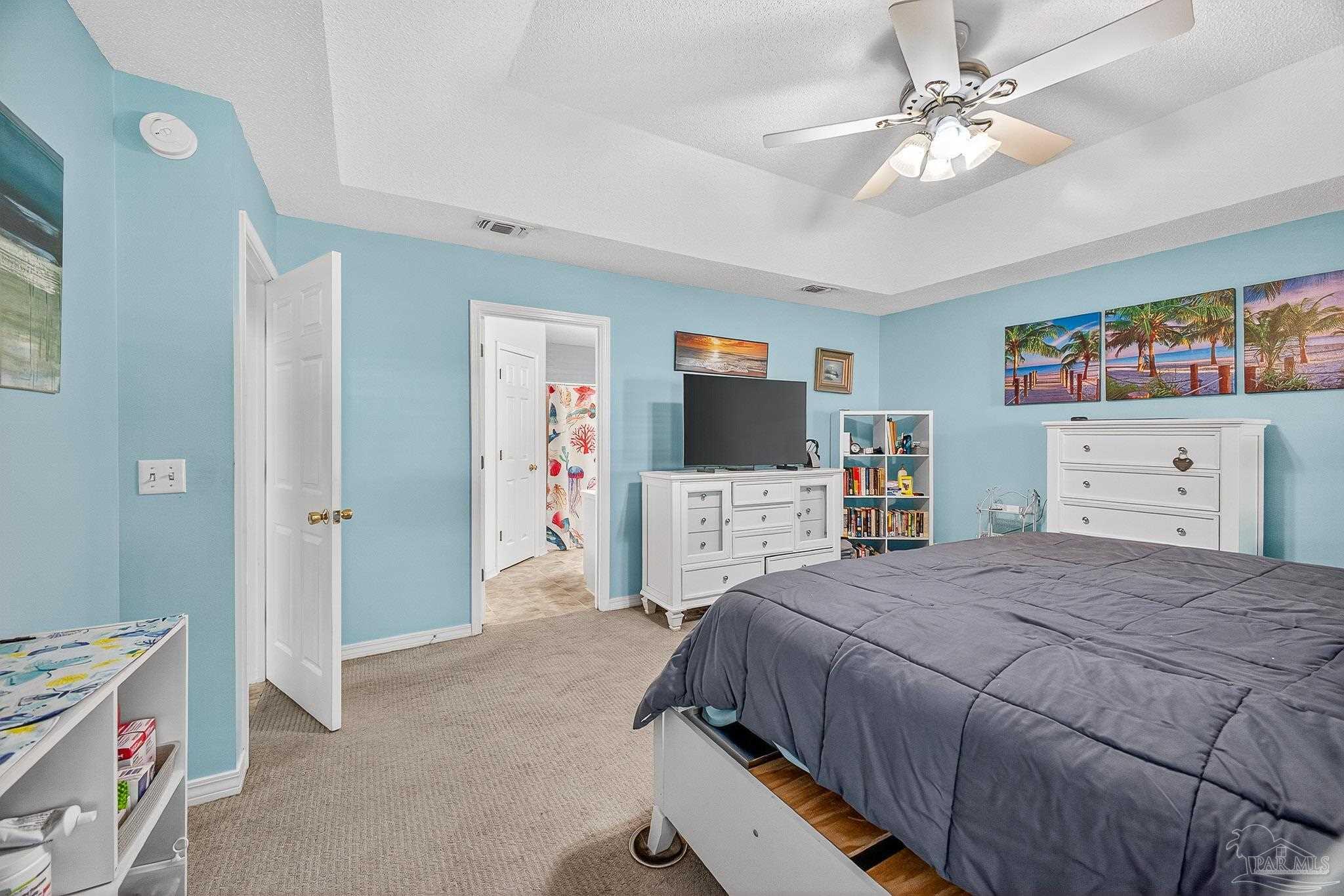 4650 Ridge Pointe Drive Pace, FL 32571 - Photo 25 of 38 a bedroom with a bed and a flat screen tv