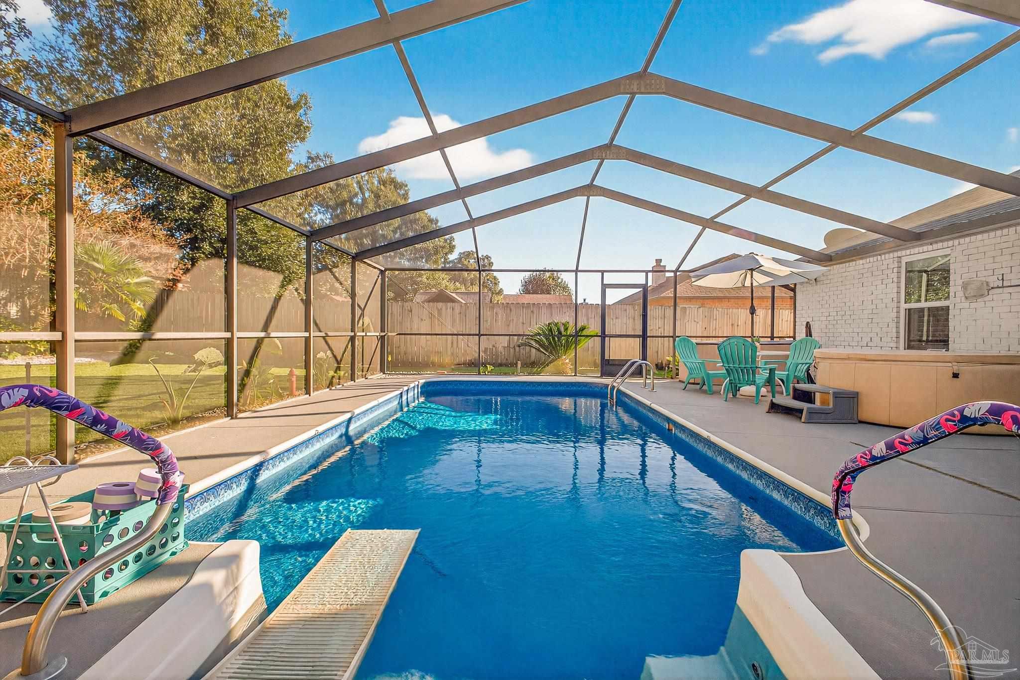 4650 Ridge Pointe Drive Pace, FL 32571 - Photo 30 of 38 a view of a swimming pool with a patio
