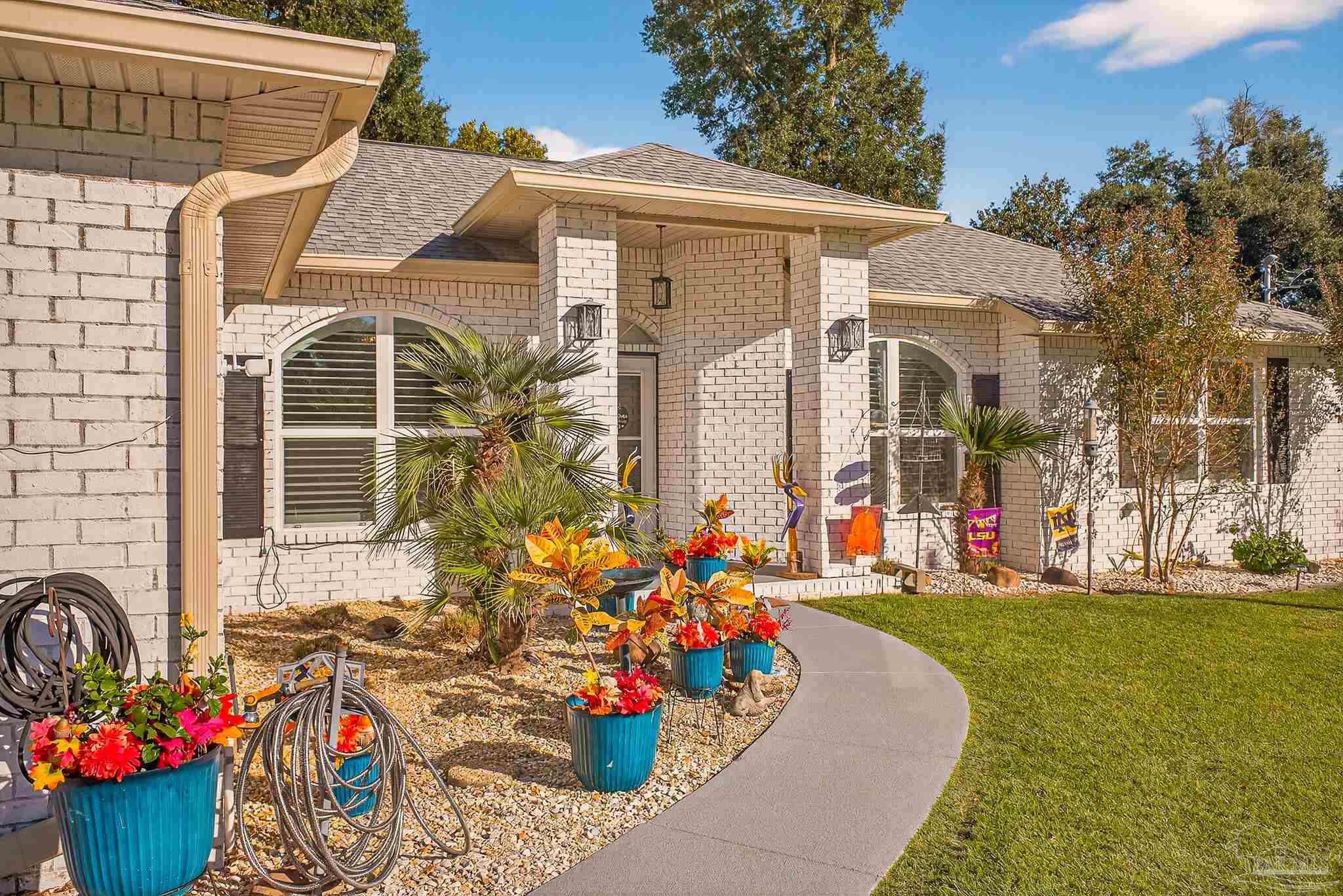 4650 Ridge Pointe Drive Pace, FL 32571 - Photo 3 of 38 a front view of a house with many windows