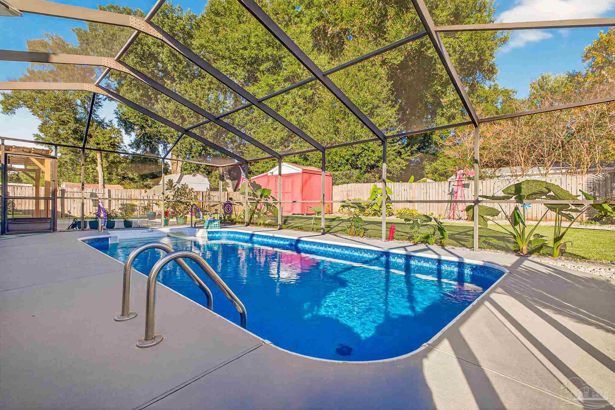 4650 Ridge Pointe Drive Pace, FL 32571 - Photo 31 of 38 a view of a swimming pool with a patio