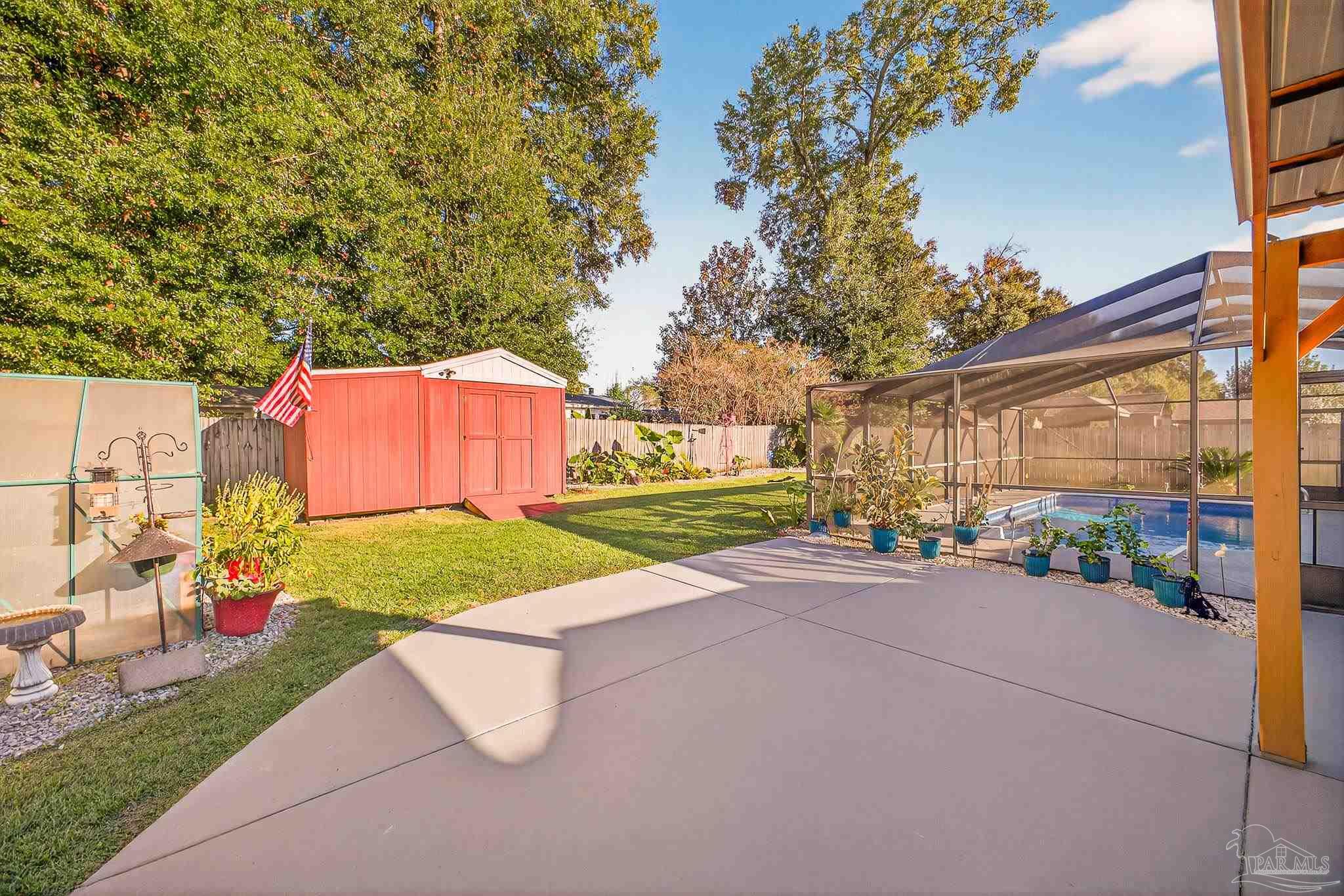 4650 Ridge Pointe Drive Pace, FL 32571 - Photo 33 of 38 a view of a backyard with a garden and plants