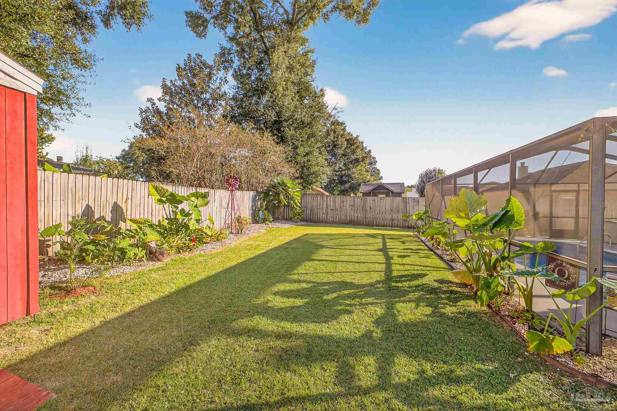 4650 Ridge Pointe Drive Pace, FL 32571 - Photo 36 of 38 a view of swimming pool with a garden