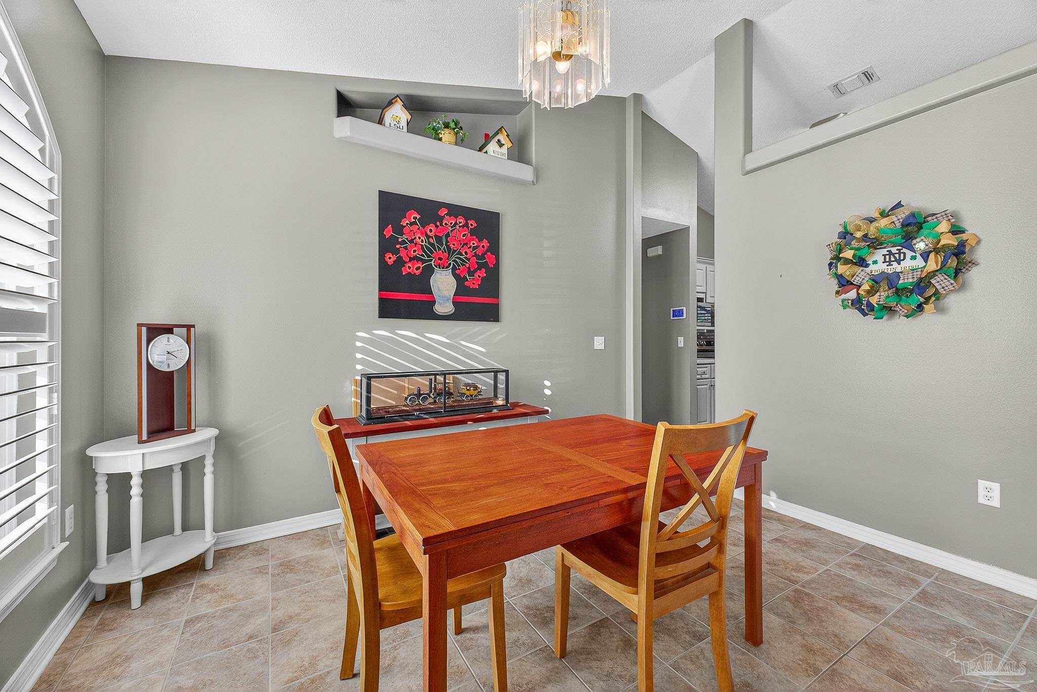 4650 Ridge Pointe Drive Pace, FL 32571 - Photo 4 of 38 a view of a dining room with furniture