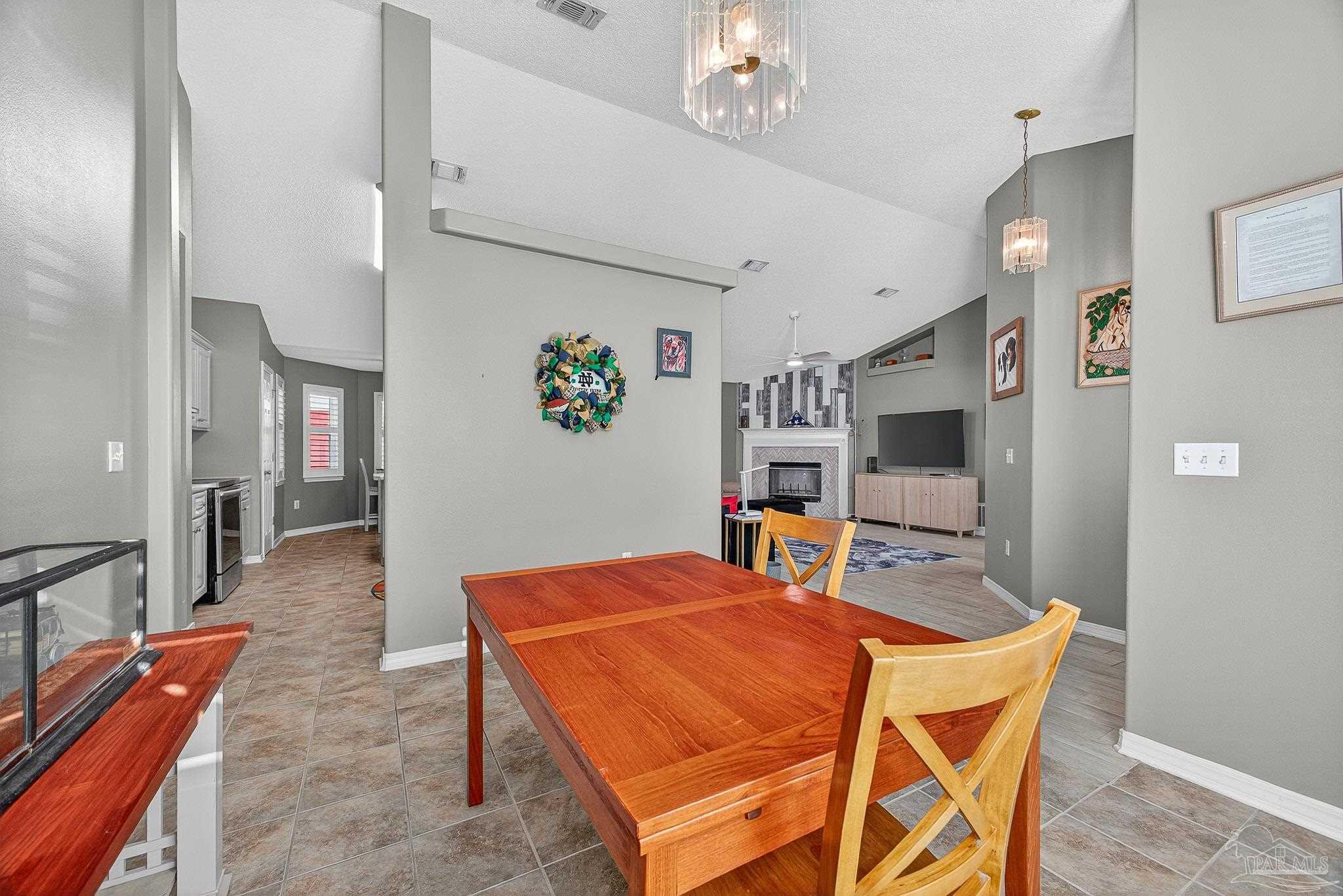 4650 Ridge Pointe Drive Pace, FL 32571 - Photo 5 of 38 a dining room with furniture and wooden floor