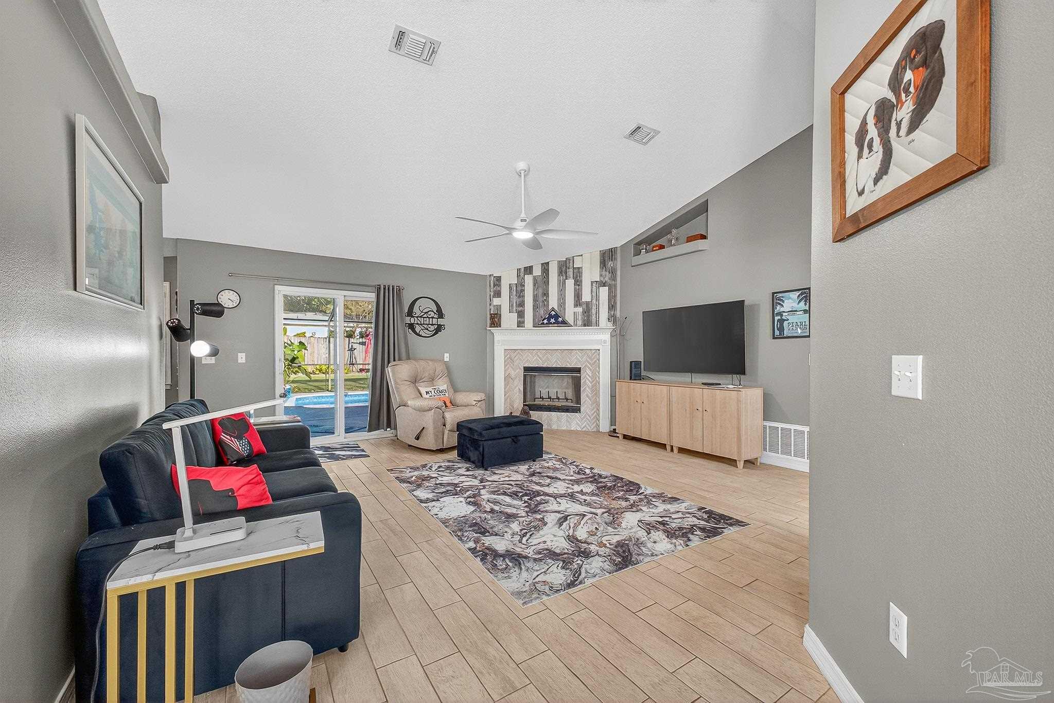 4650 Ridge Pointe Drive Pace, FL 32571 - Photo 8 of 38 a living room with furniture and a flat screen tv