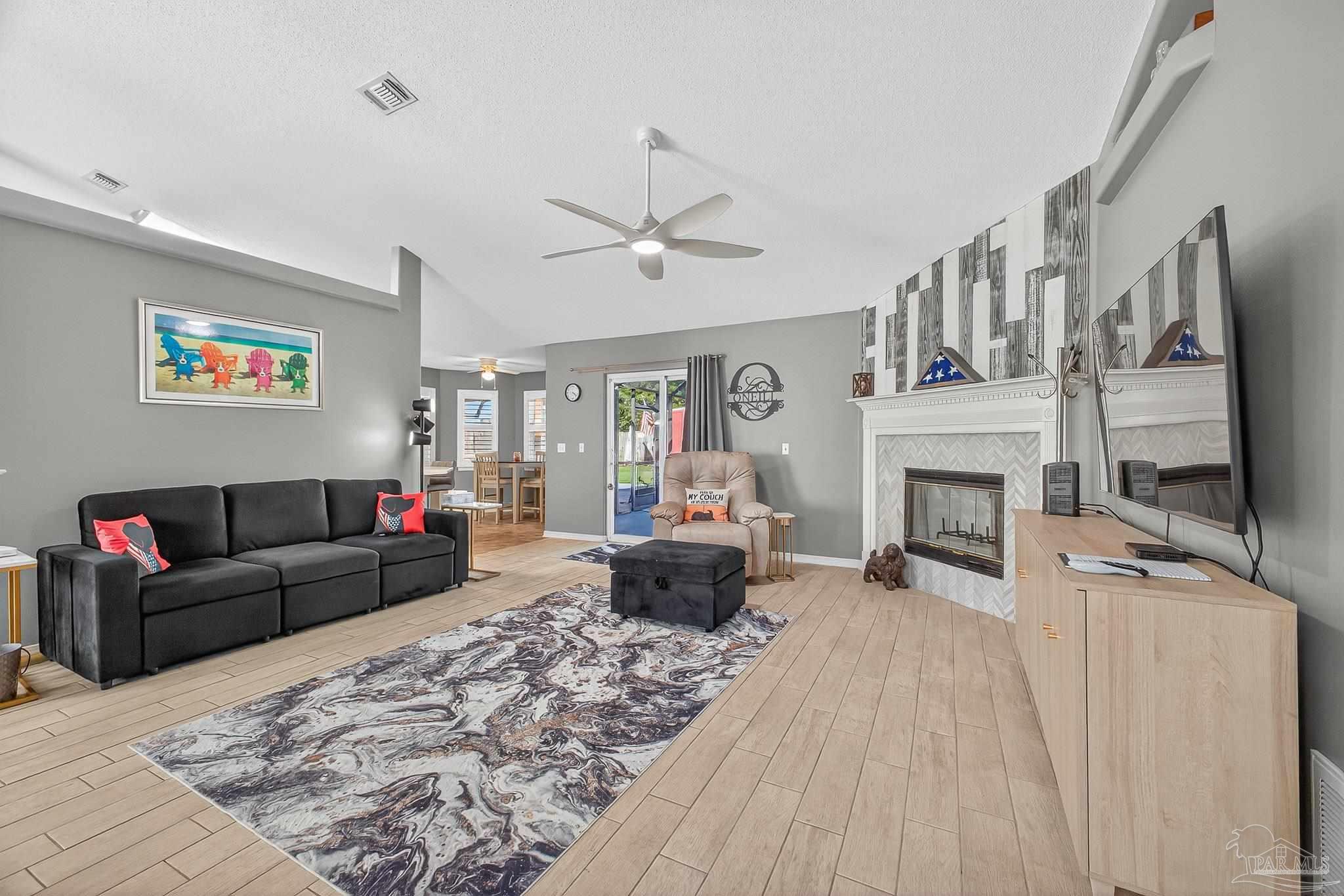 4650 Ridge Pointe Drive Pace, FL 32571 - Photo 9 of 38 a living room with furniture and a fireplace