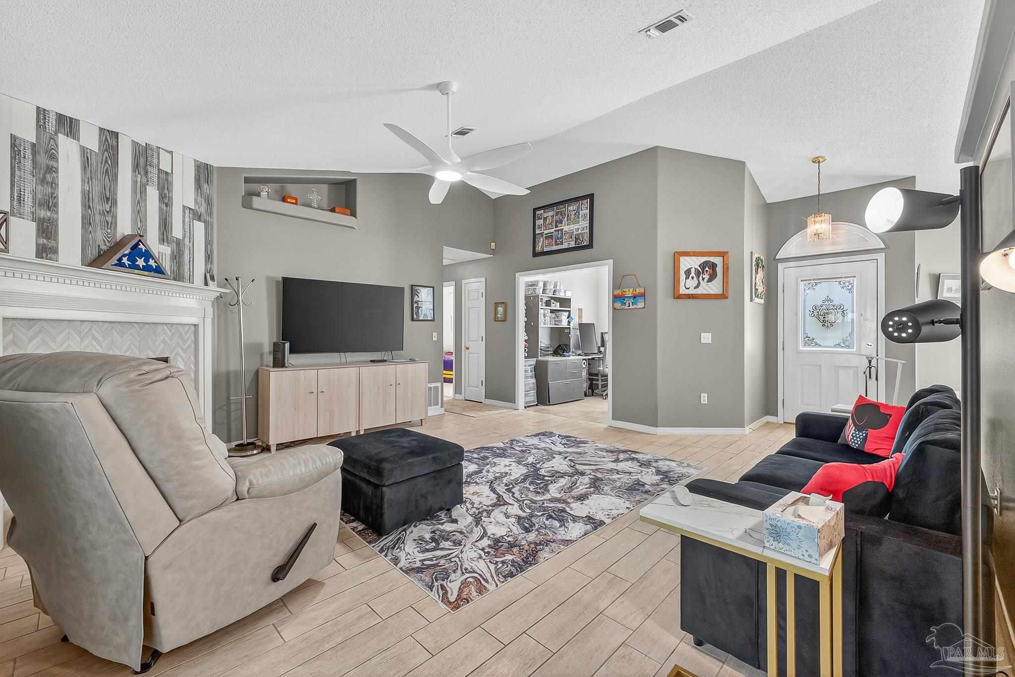 4650 Ridge Pointe Drive Pace, FL 32571 - Photo 10 of 38 a living room with furniture and a flat screen tv