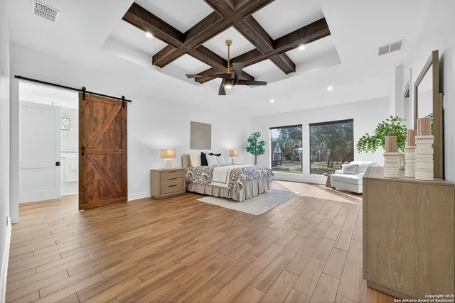a bedroom with furniture and a potted plant