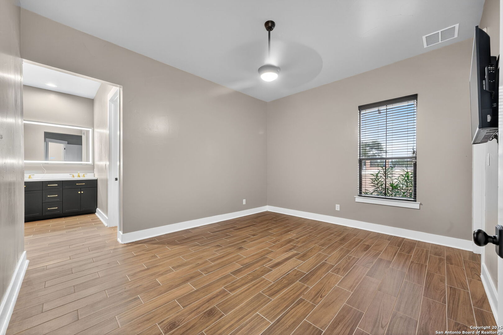 1115 Meadow Stone Court Spring Branch, TX 78070 - Photo 22 of 42 a view of an empty room with wooden floor and a window
