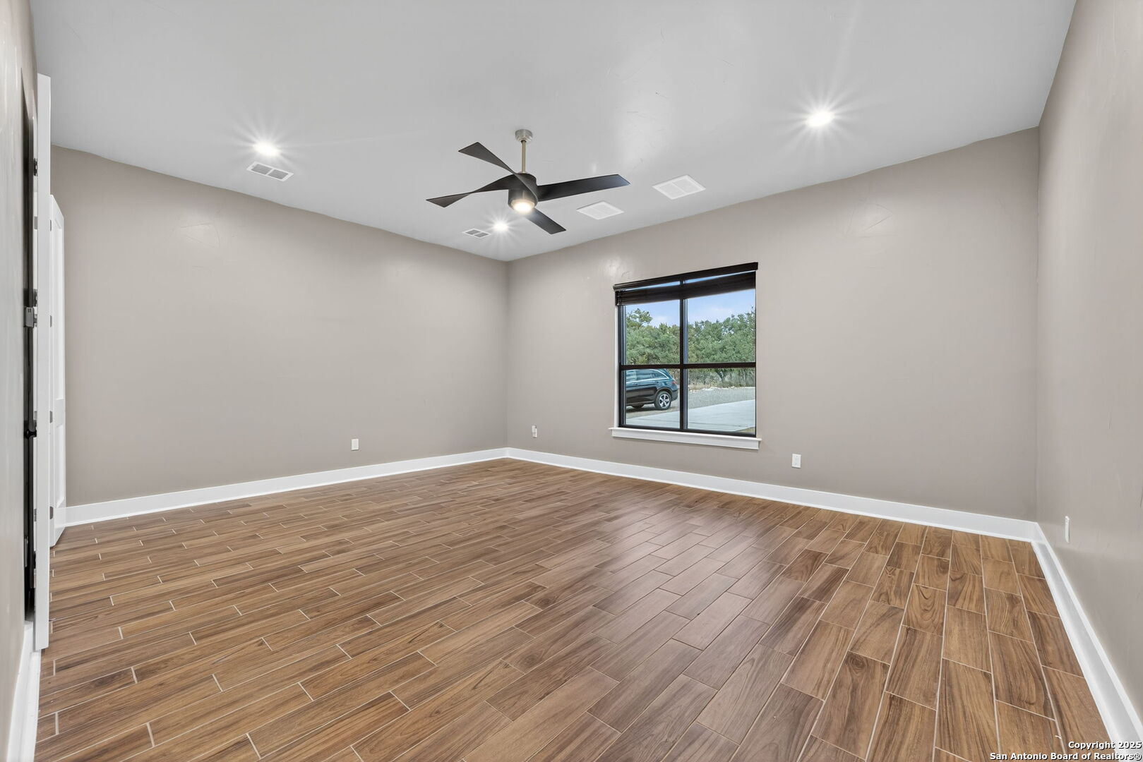 1115 Meadow Stone Court Spring Branch, TX 78070 - Photo 25 of 42 wooden floor in an empty room with a window