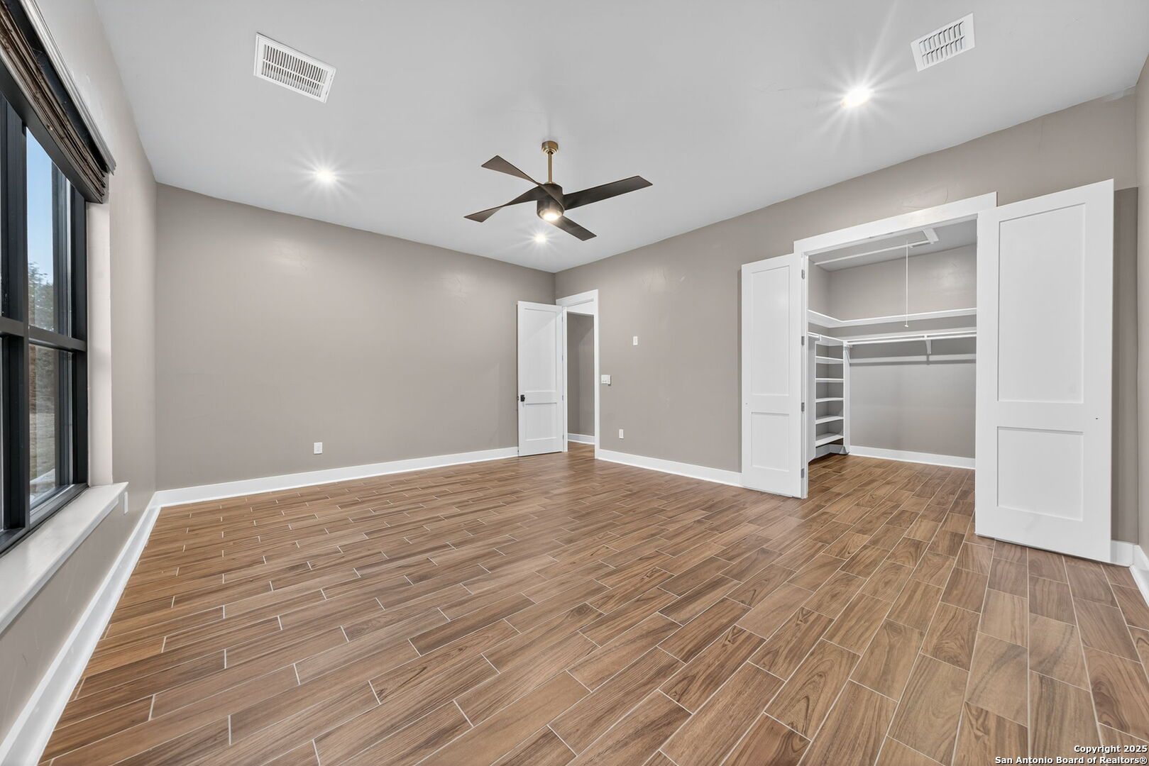 1115 Meadow Stone Court Spring Branch, TX 78070 - Photo 26 of 42 wooden floor in an empty room with a window