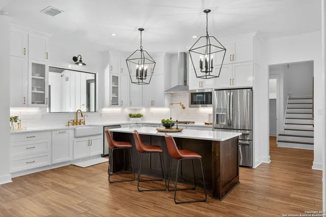 a large kitchen with a table and chairs in it