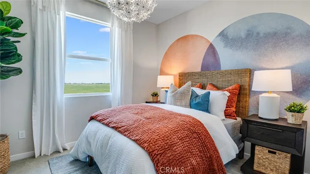 a bed sitting in a bedroom next to a window