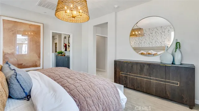 a bedroom with a bed and a painting on the wall