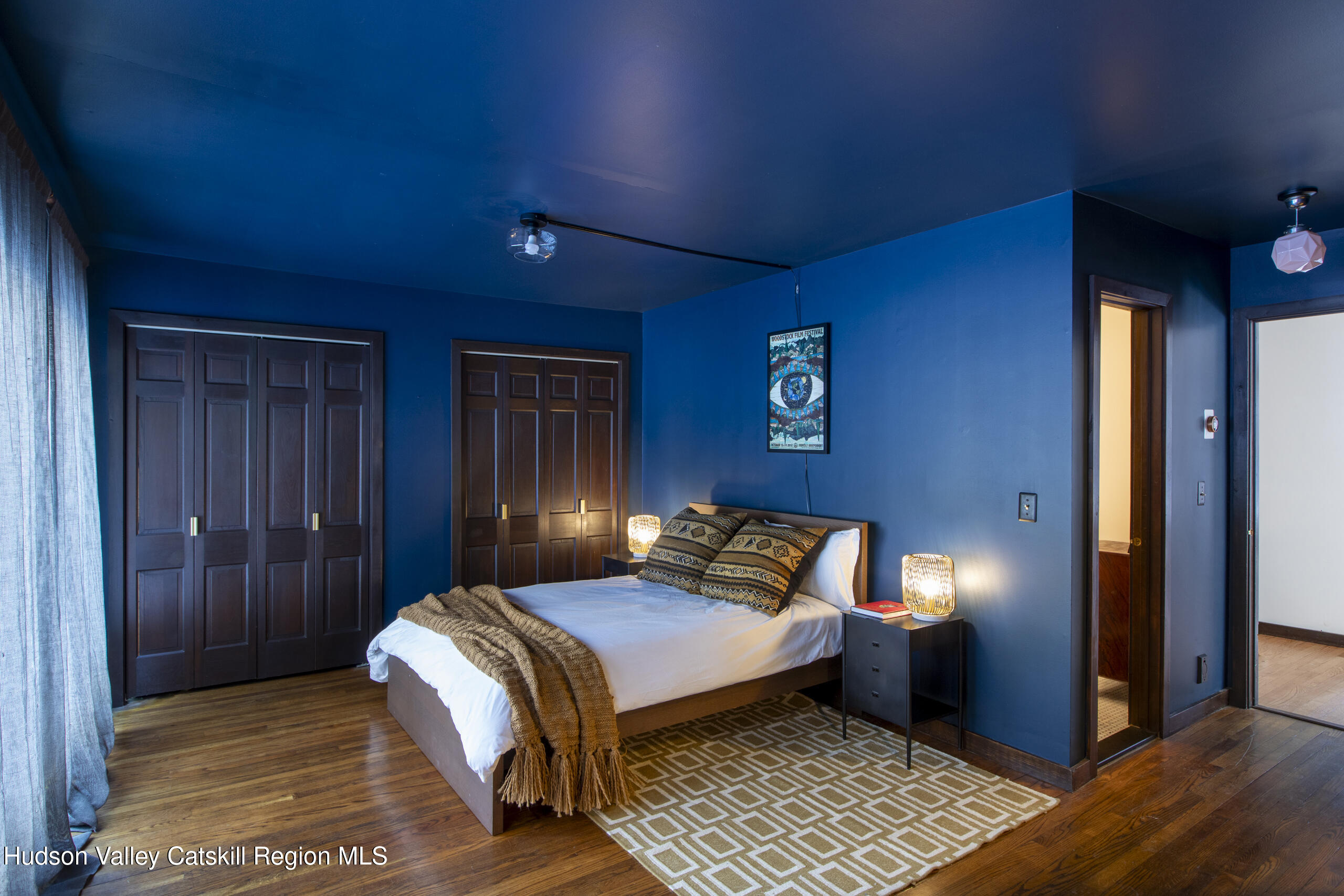 348 Willow Glen Road Red Hook, NY 12571 - Photo 17 of 29 a bedroom with a bed and wooden floor