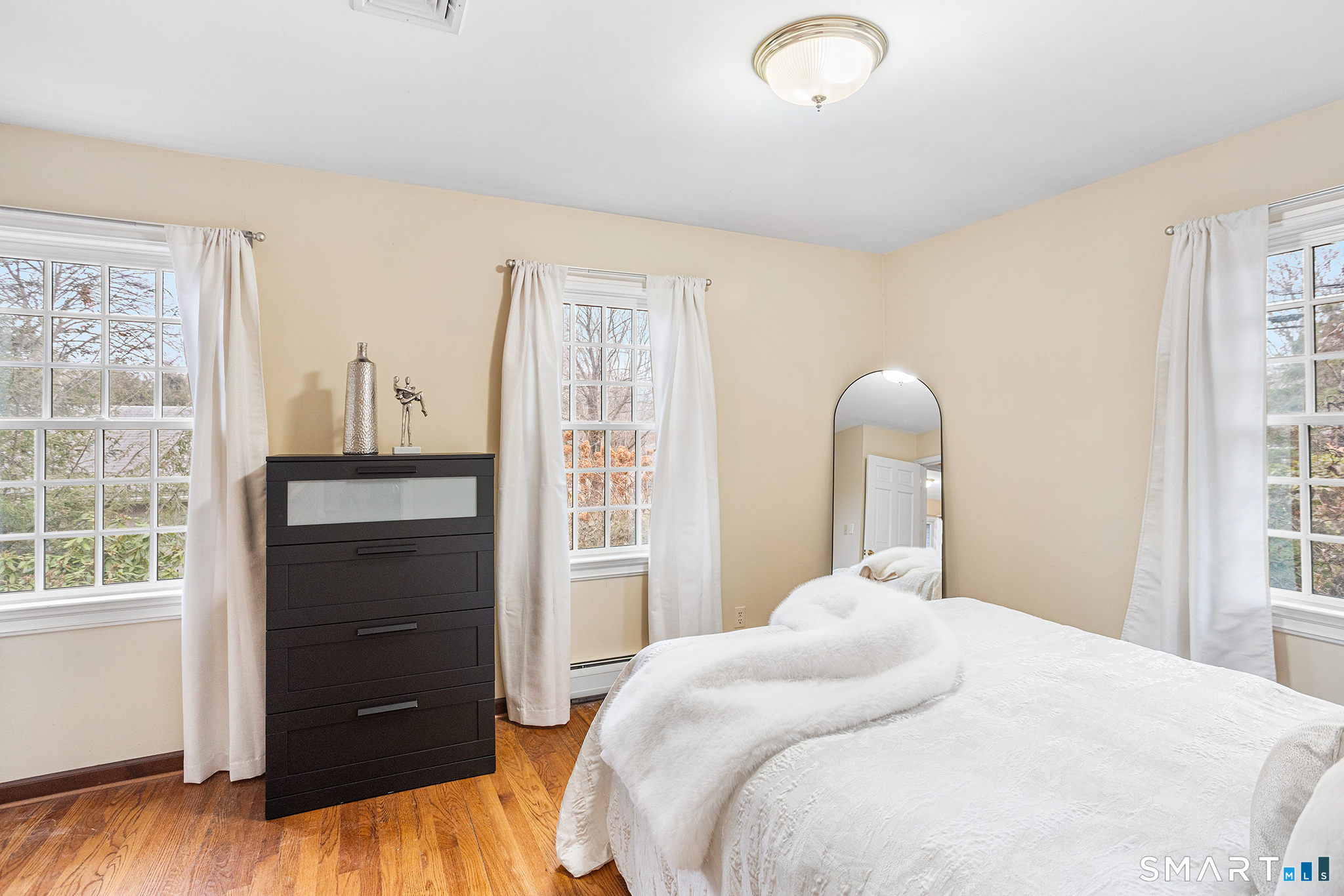 104 Putting Green Road Fairfield, CT 06825 - Photo 17 of 35 a bedroom with a bed and a window