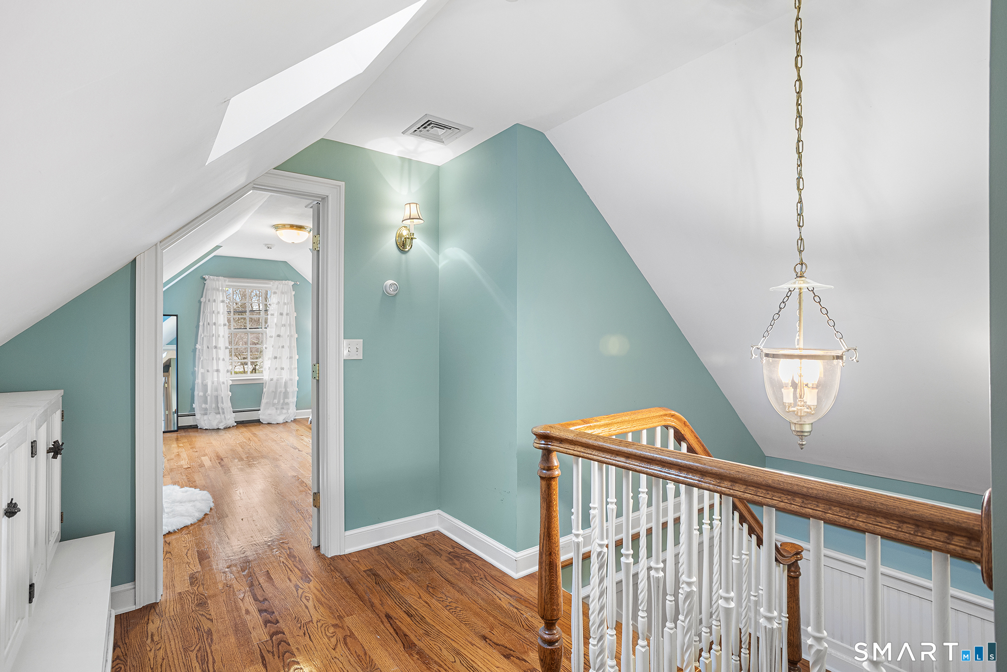104 Putting Green Road Fairfield, CT 06825 - Photo 19 of 35 a view of a hallway with wooden floor and staircase