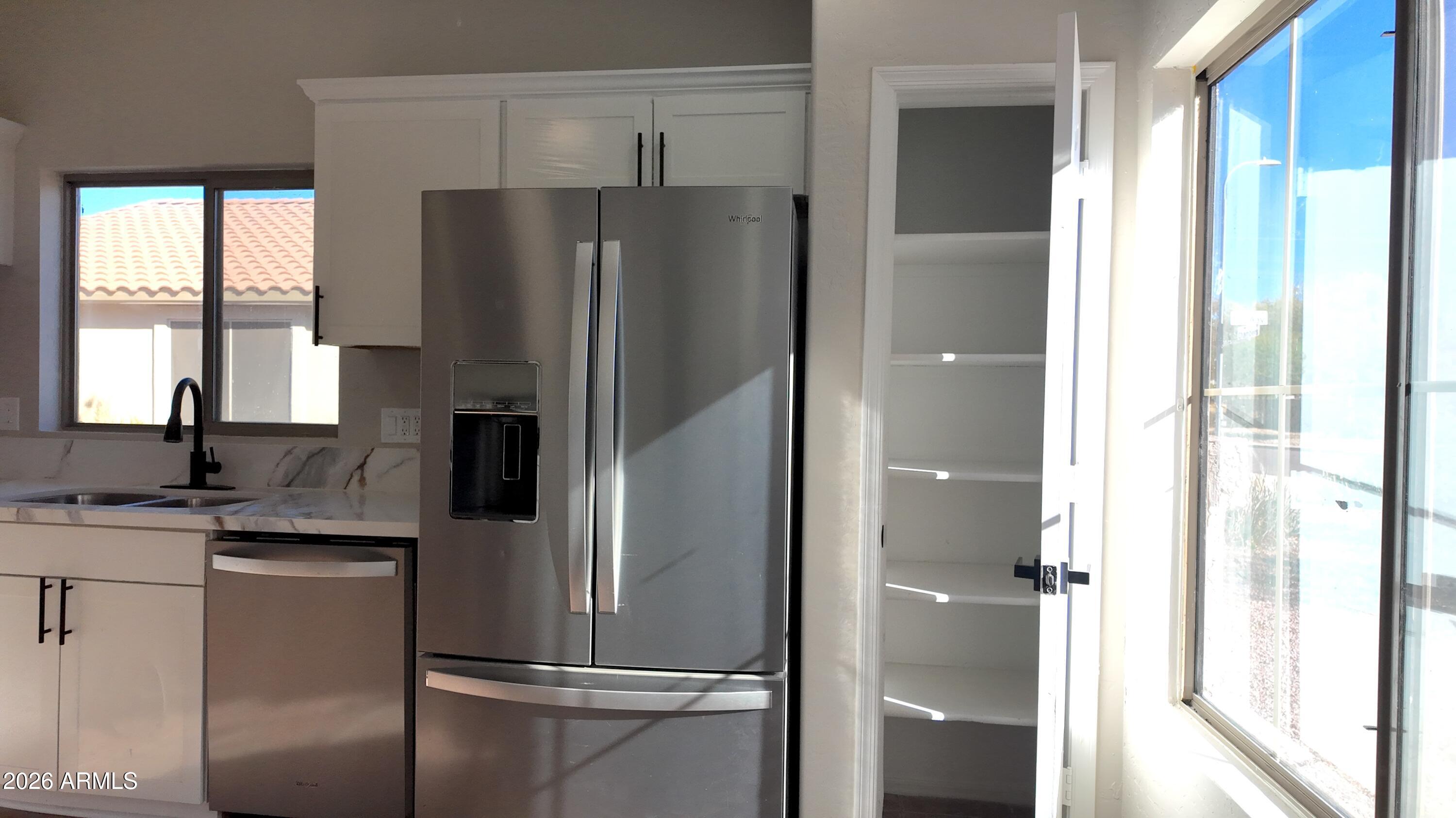 1522 East Chambers Street Phoenix, AZ 85040 - Photo 12 of 29 a kitchen with stainless steel appliances a refrigerator and a sink