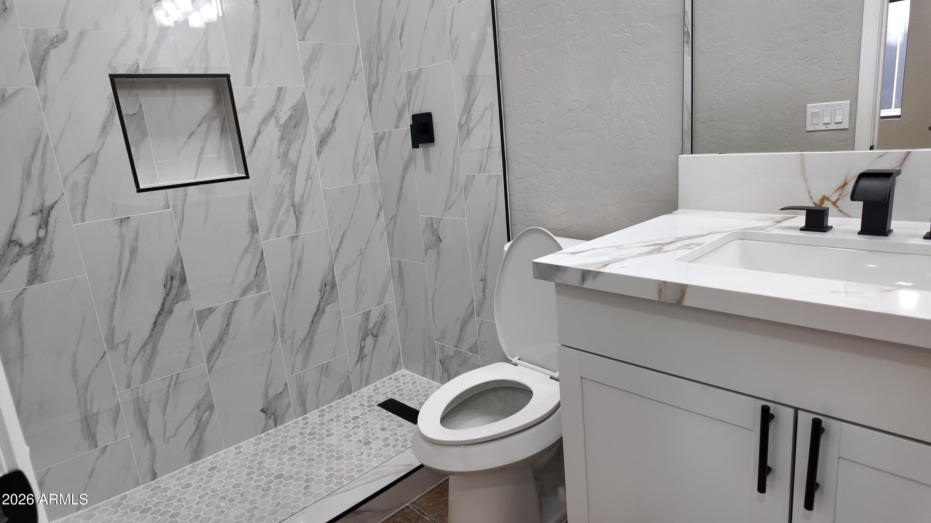 1522 East Chambers Street Phoenix, AZ 85040 - Photo 15 of 29 a bathroom with a granite countertop sink and a mirror