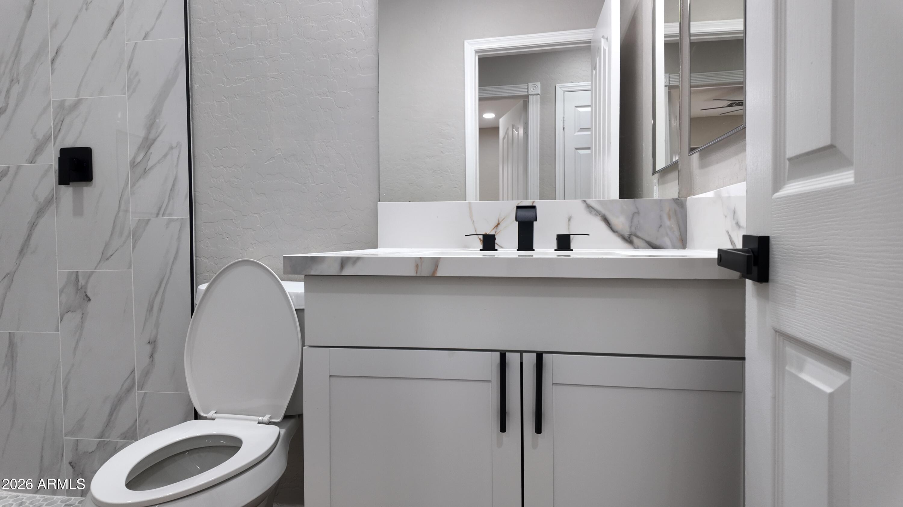 1522 East Chambers Street Phoenix, AZ 85040 - Photo 16 of 29 a bathroom with a sink toilet and mirror