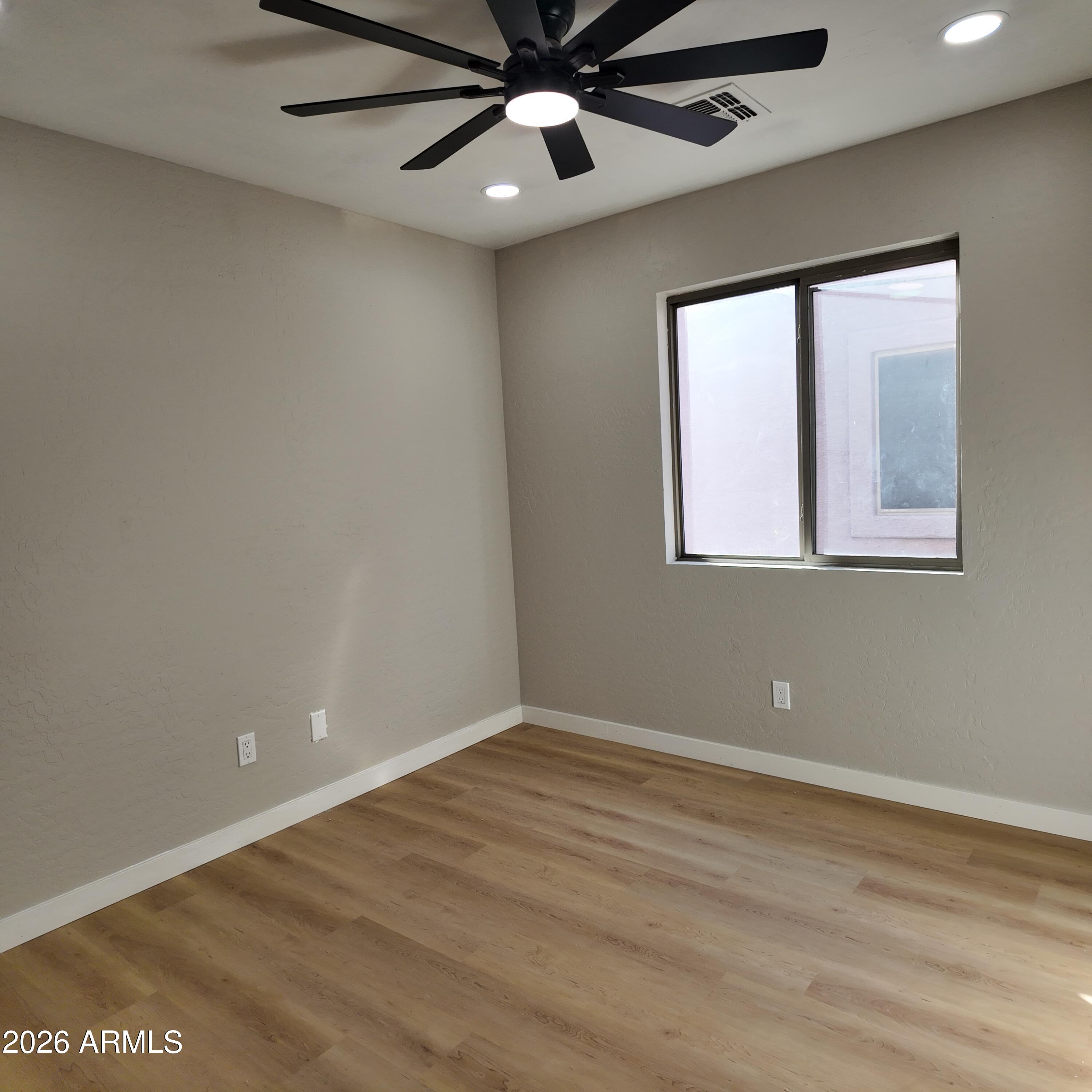 1522 East Chambers Street Phoenix, AZ 85040 - Photo 19 of 29 an empty room with windows and fan