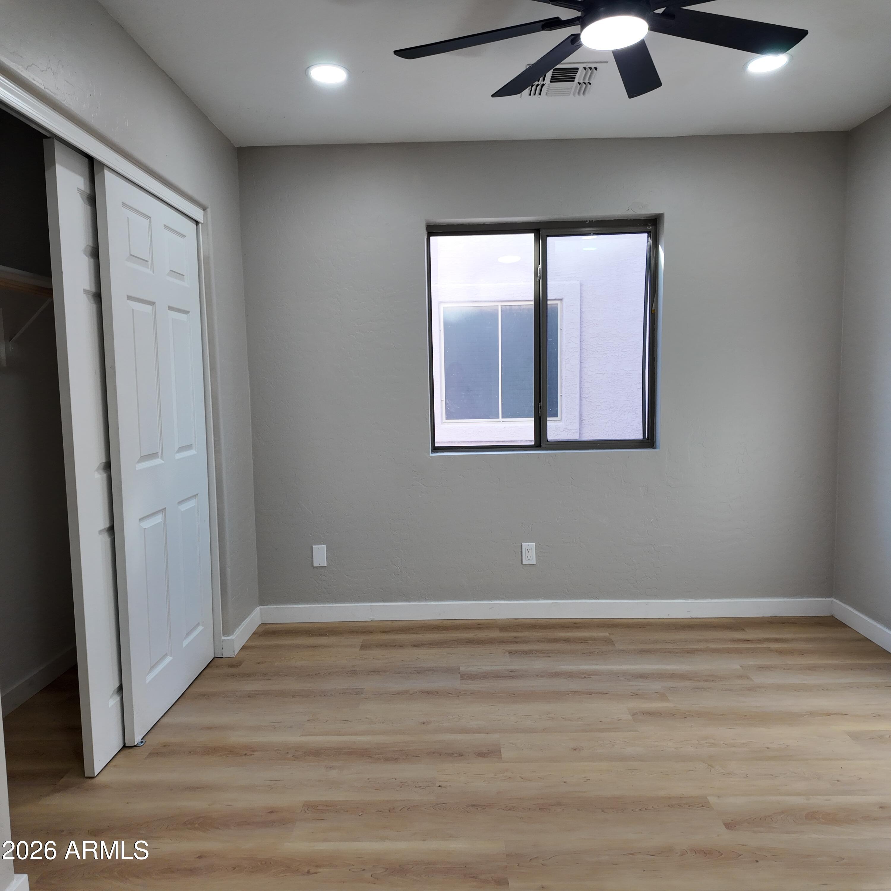 1522 East Chambers Street Phoenix, AZ 85040 - Photo 20 of 29 an empty room with wooden floor and windows