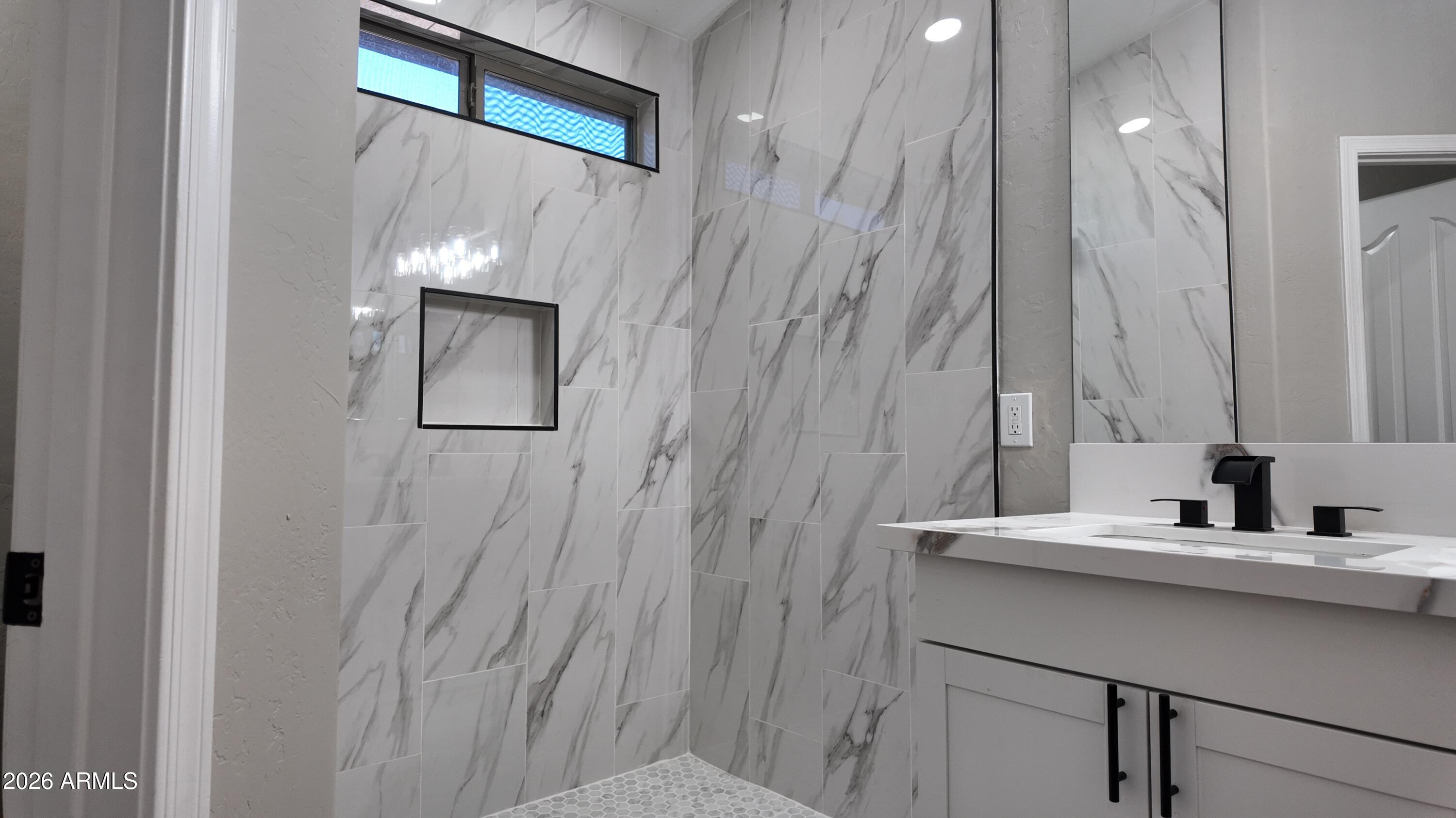 1522 East Chambers Street Phoenix, AZ 85040 - Photo 24 of 29 a bathroom with a sink a vanity and a mirror