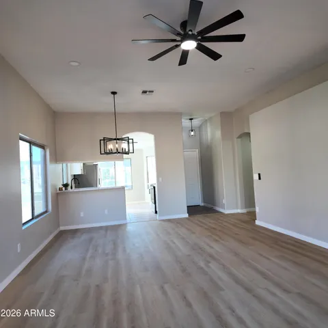 a view of a kitchen with wooden floor and a ceiling fan